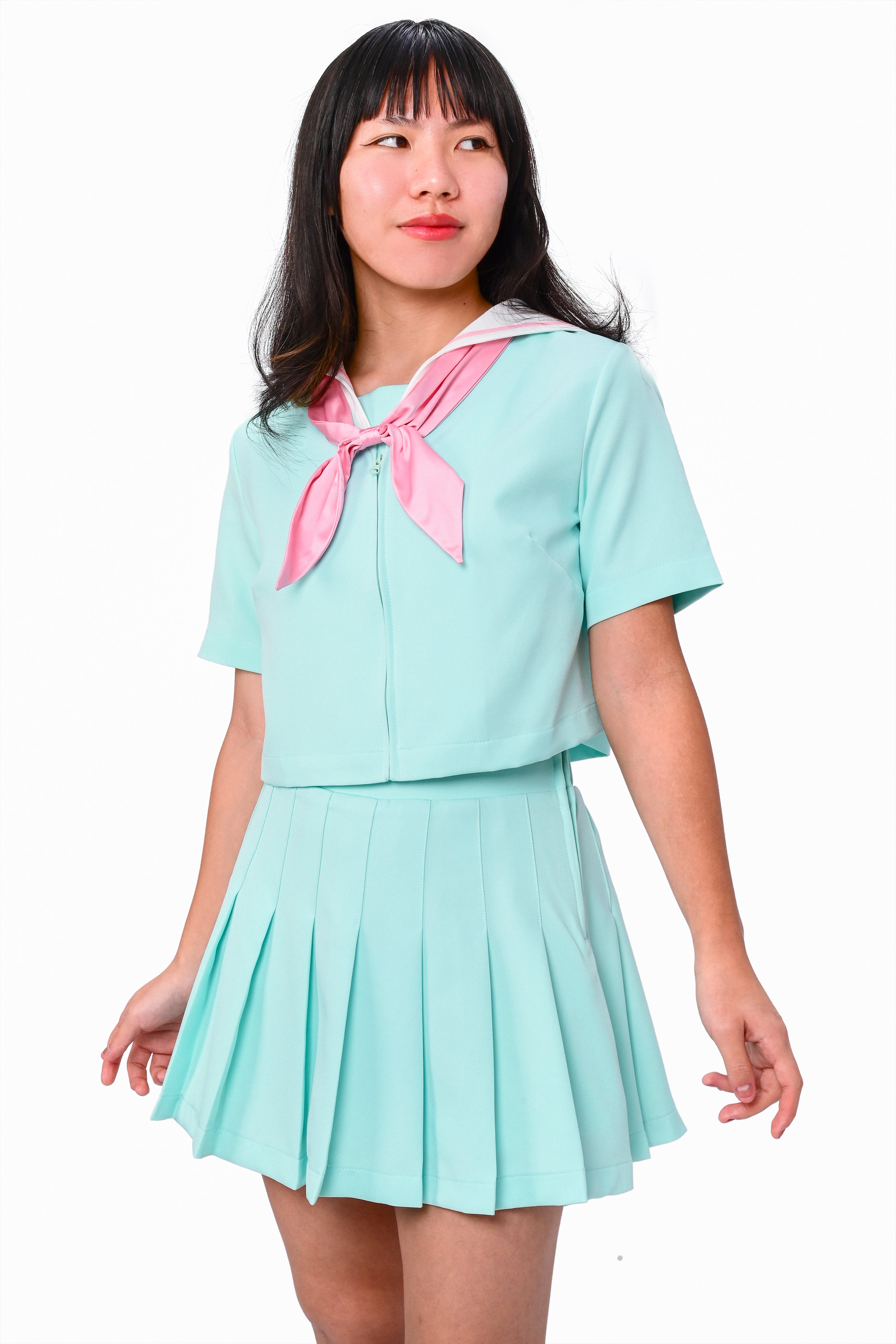 A model wearing a mint sailor collar with a pink bow and a matching pleated skirt