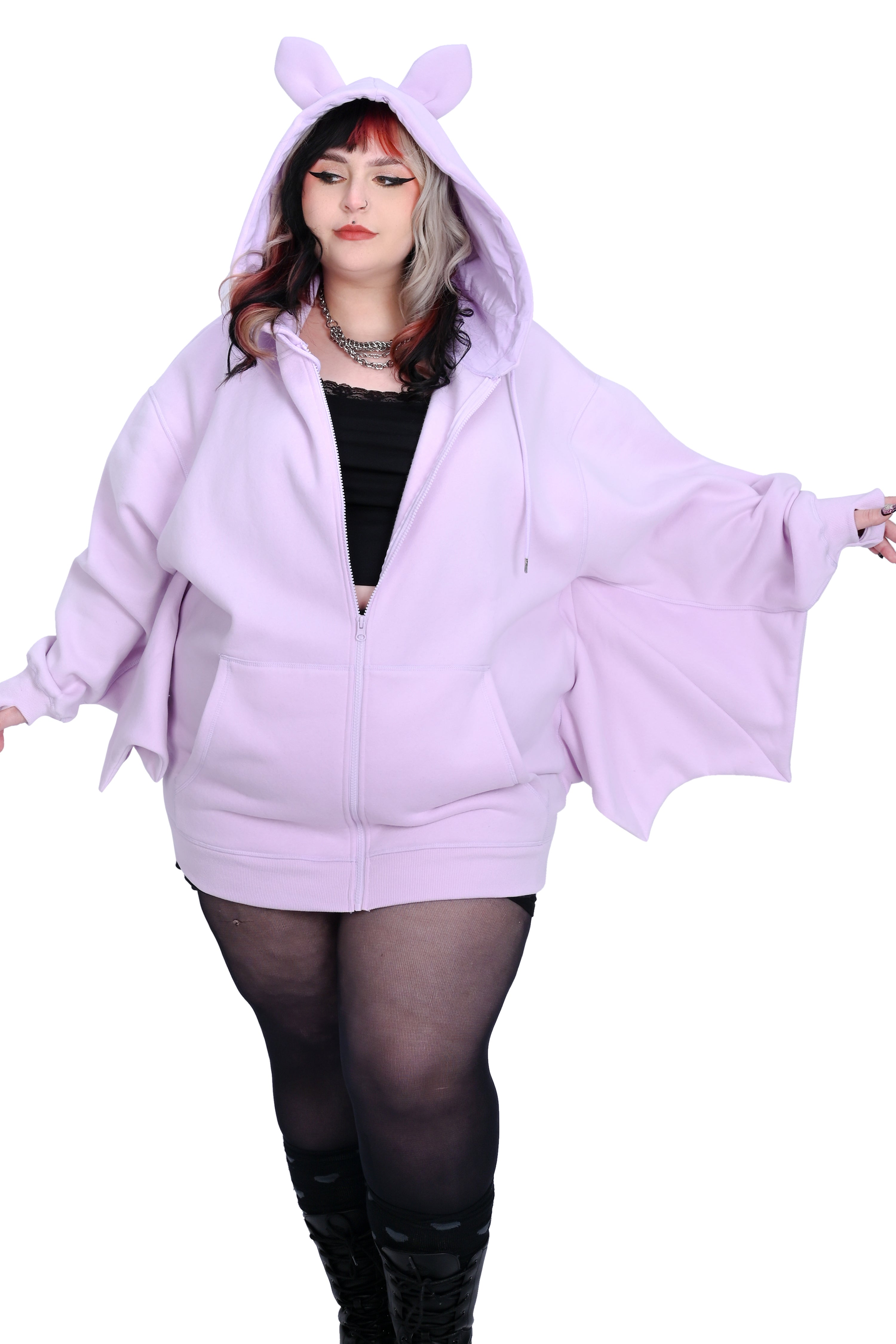 A person wearing a oversized lavender hoodie with bat ears and wing-like sleeves