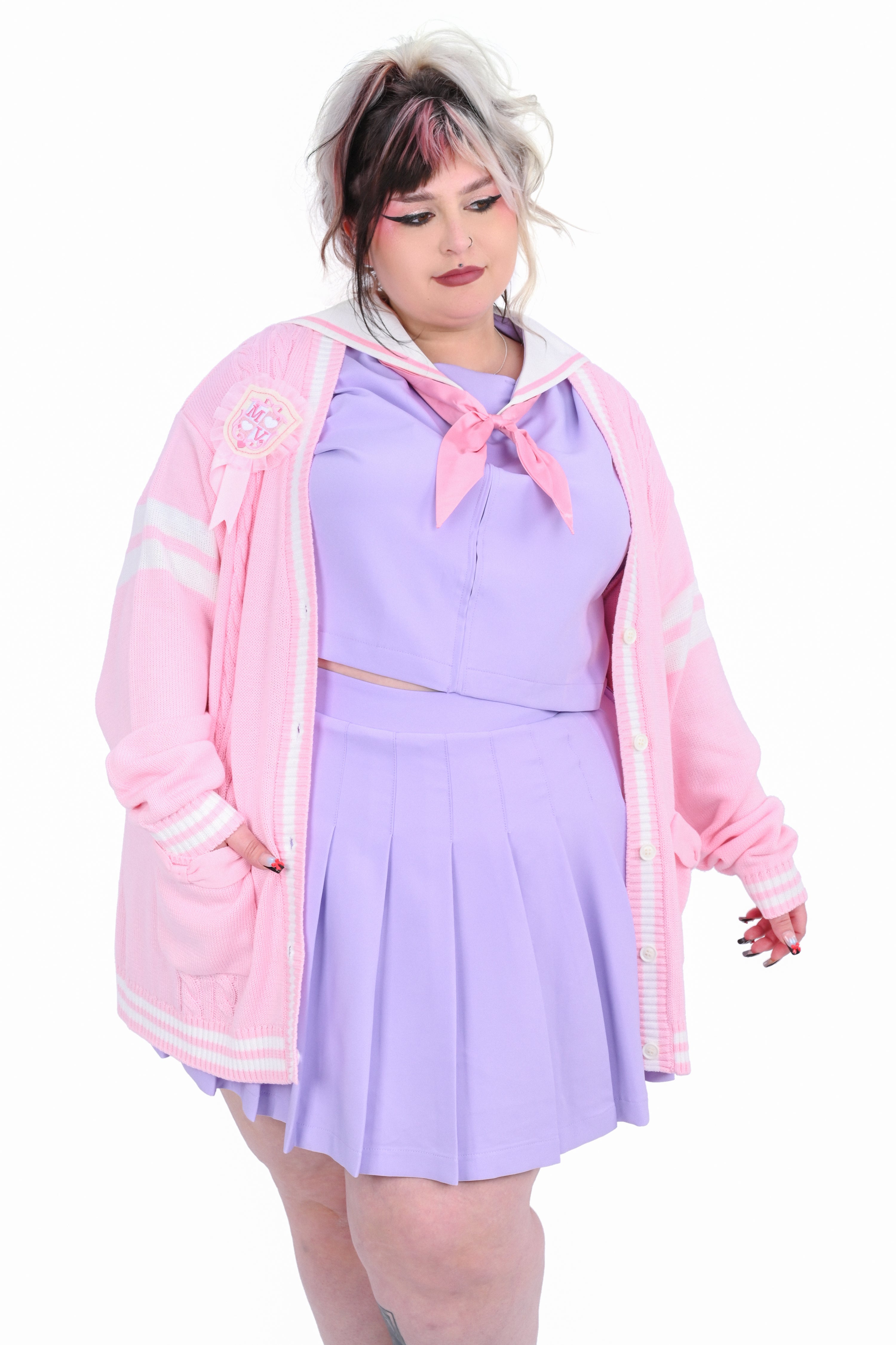 A person wearing a pink cardigan with white trim