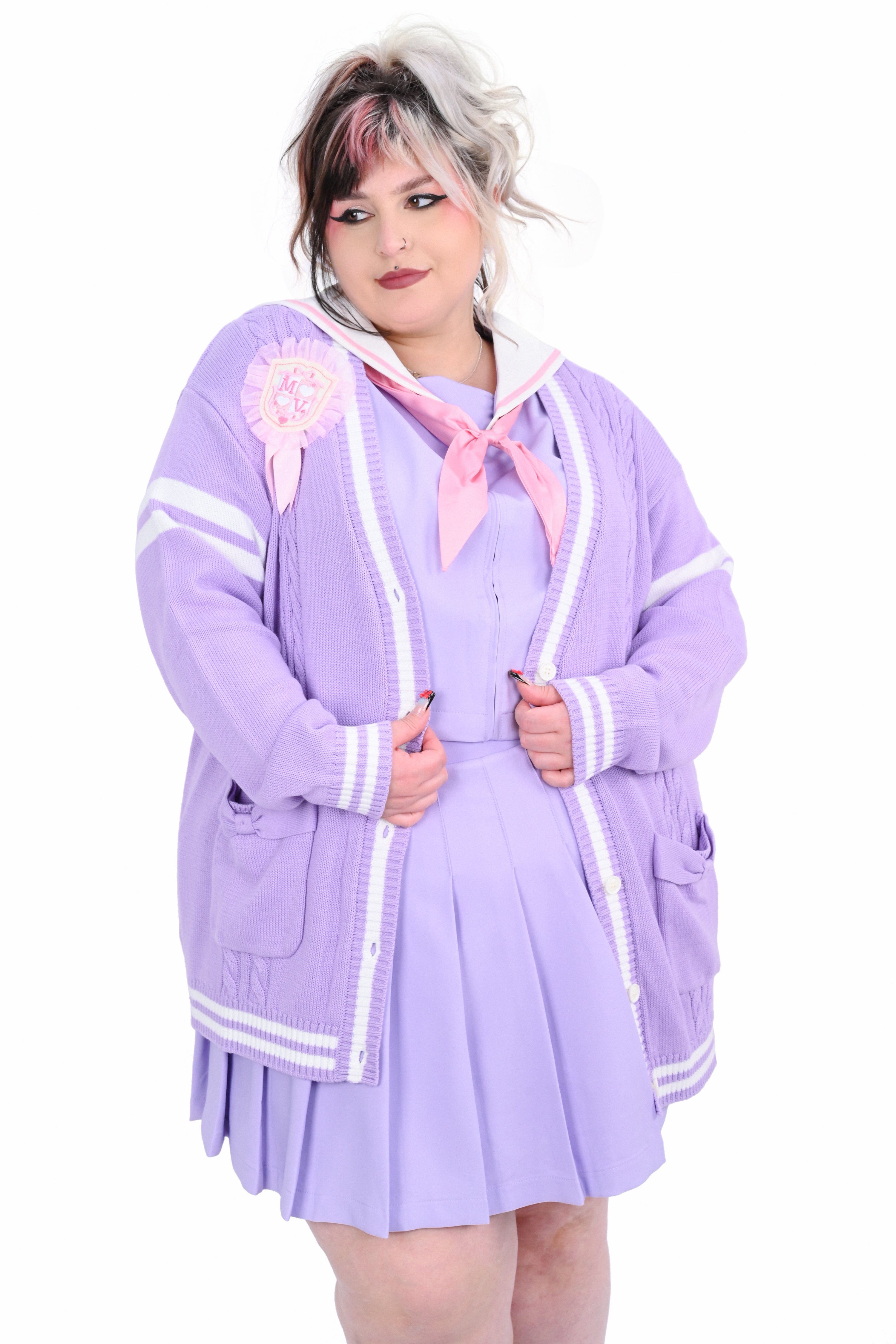A person wearing a lavender-colored cardigan with white trim