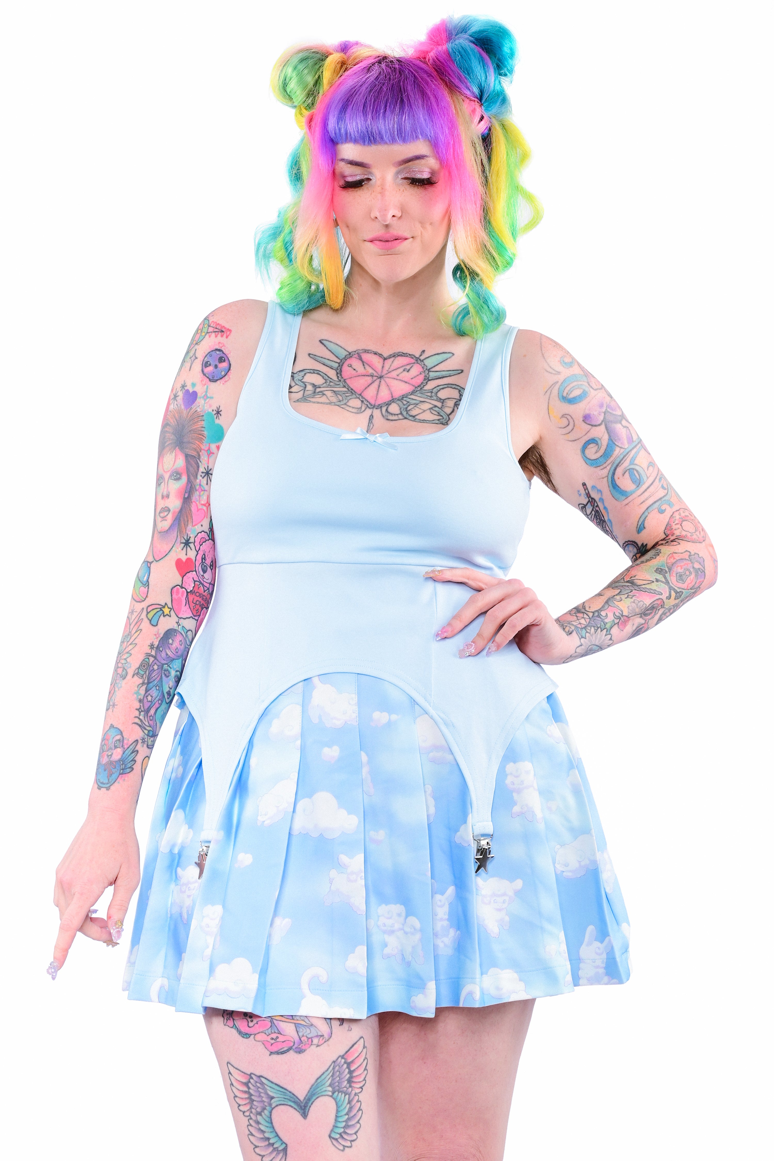A person wearing a sky blue cami top with a star-shaped garter detail.