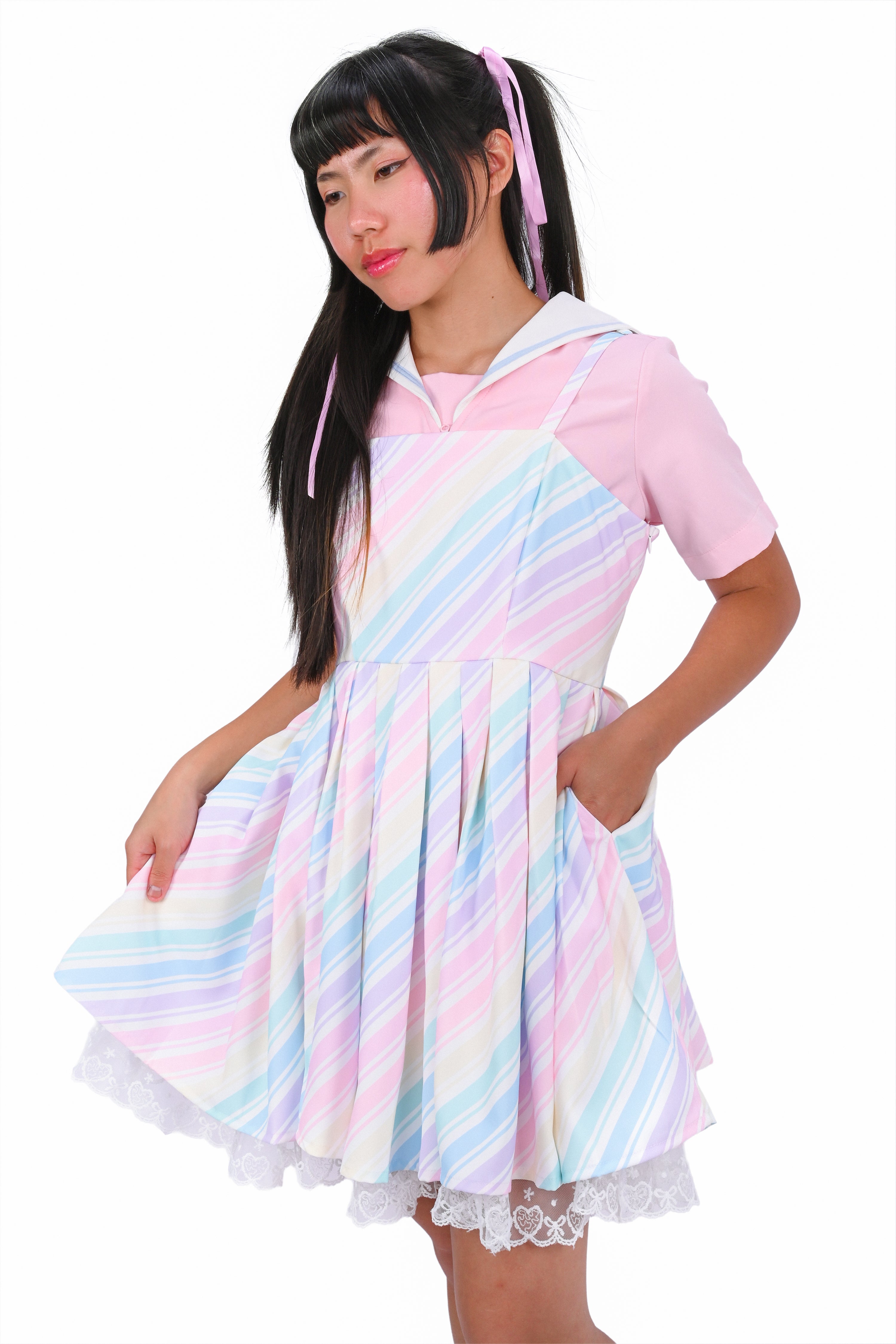 Person wearing a pastel striped dress with a white background
