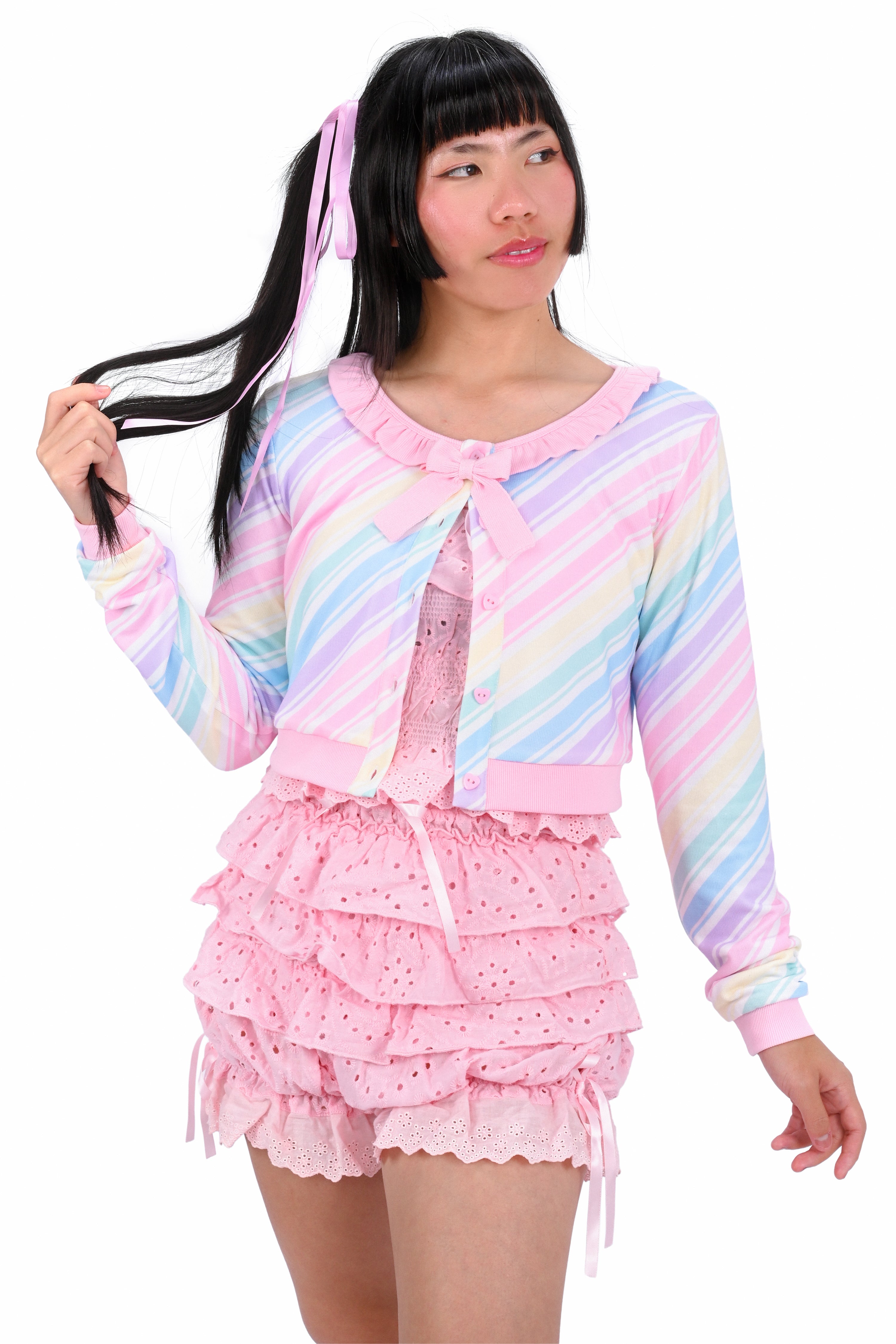 Pastel striped cardigan with ruffled pink skirt on a white background