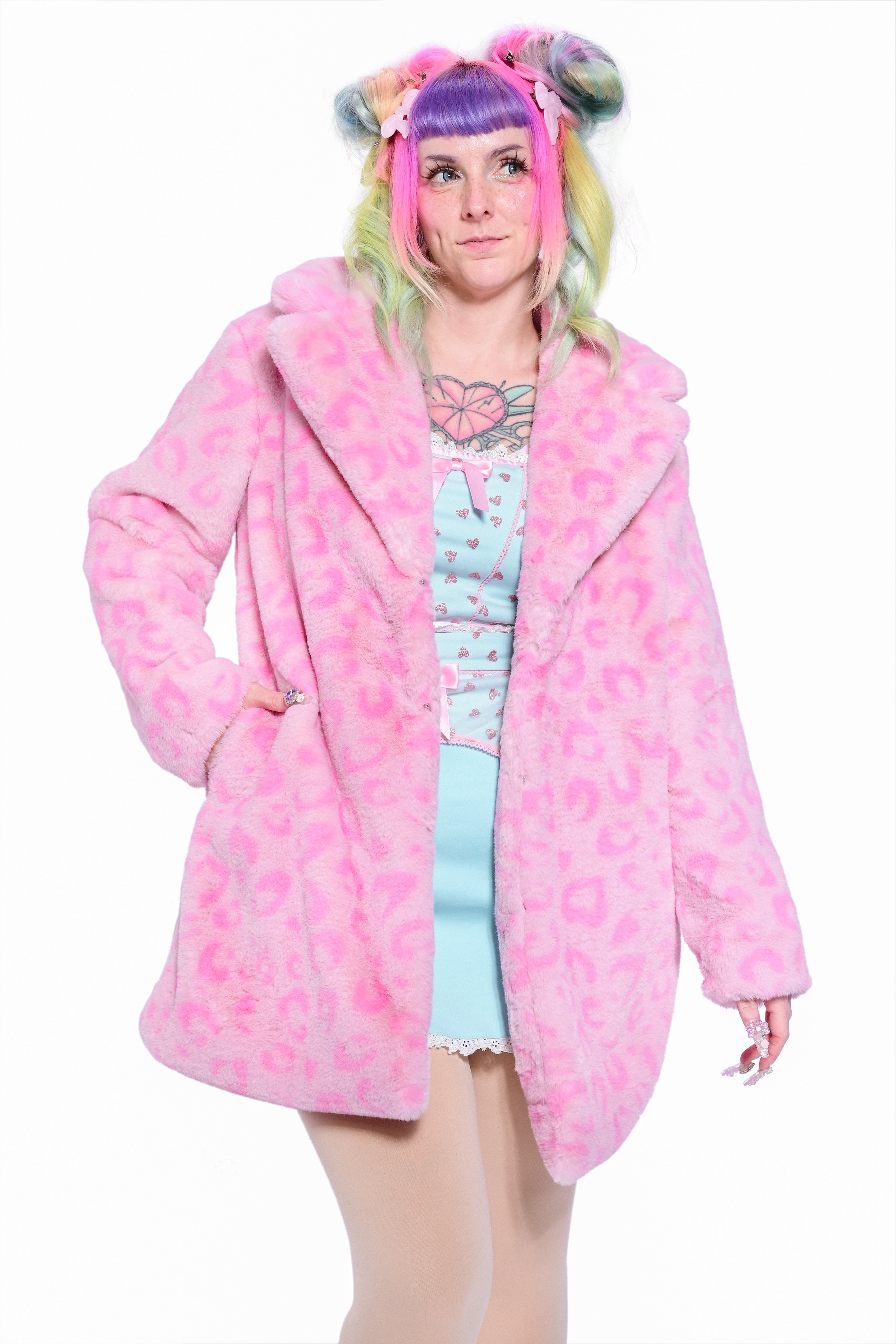 A person wearing a pink leopard print faux fur coat