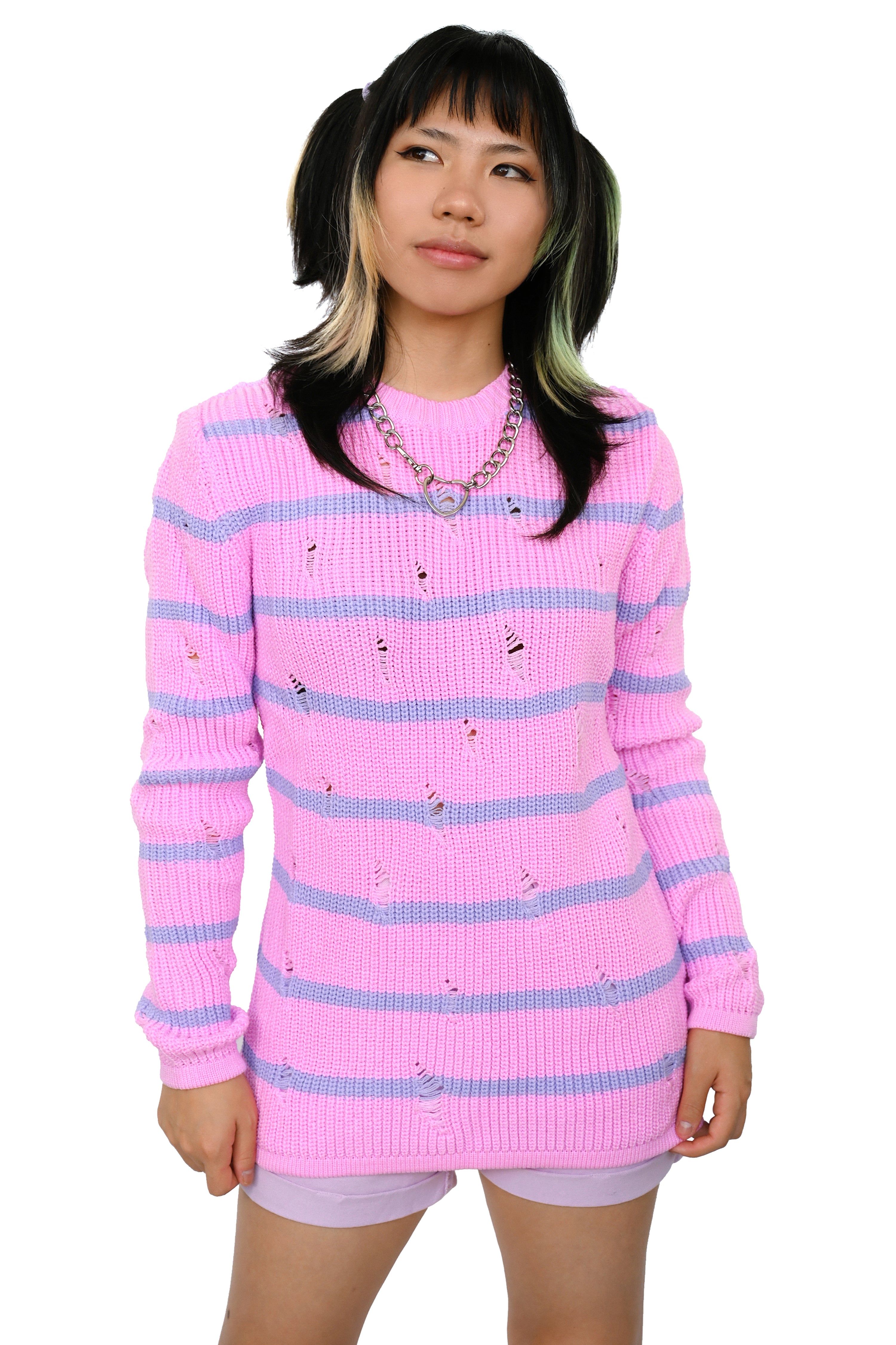 A person wearing a shredded pink sweater with lavender stripes.