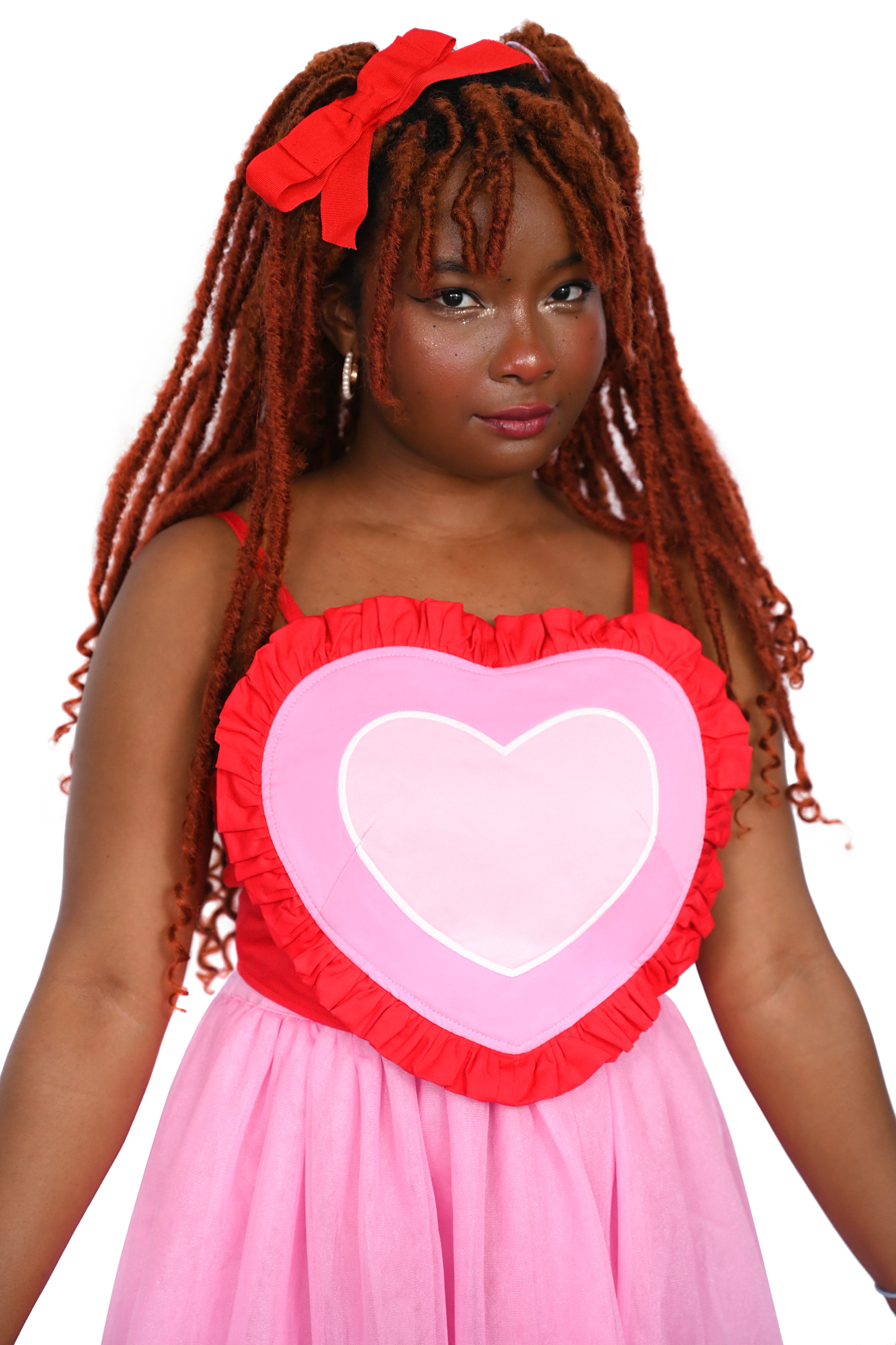 This red, pink, light pink, and white heart shaped corset top has adjustable straps and a lace-up back. The Base color of the corset top is red and a red ruffle surrounds the other colours of the heart.