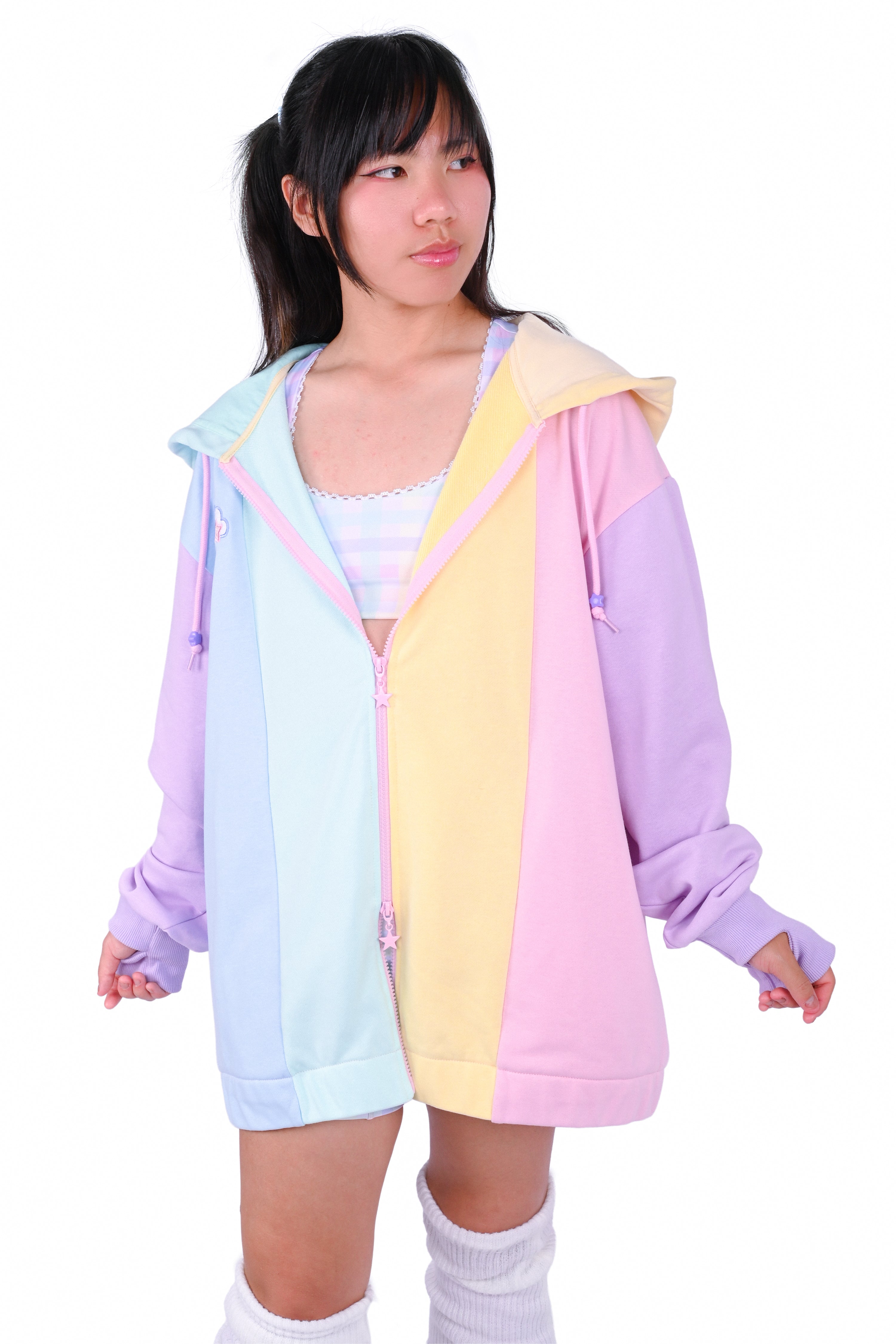Person wearing a rainbow pastel colored blocked hoodie 
