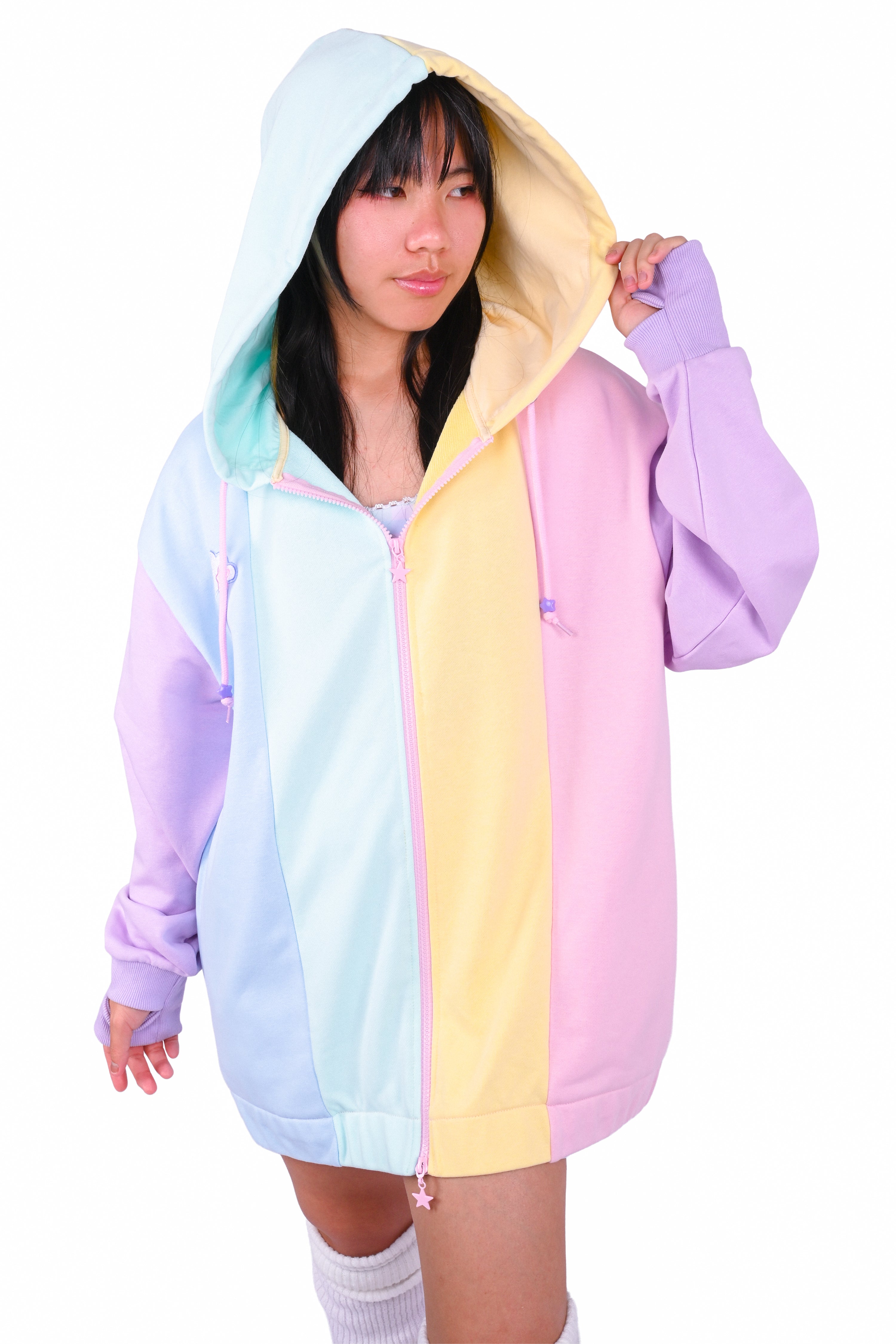 Person wearing a rainbow pastel colored blocked hoodie 