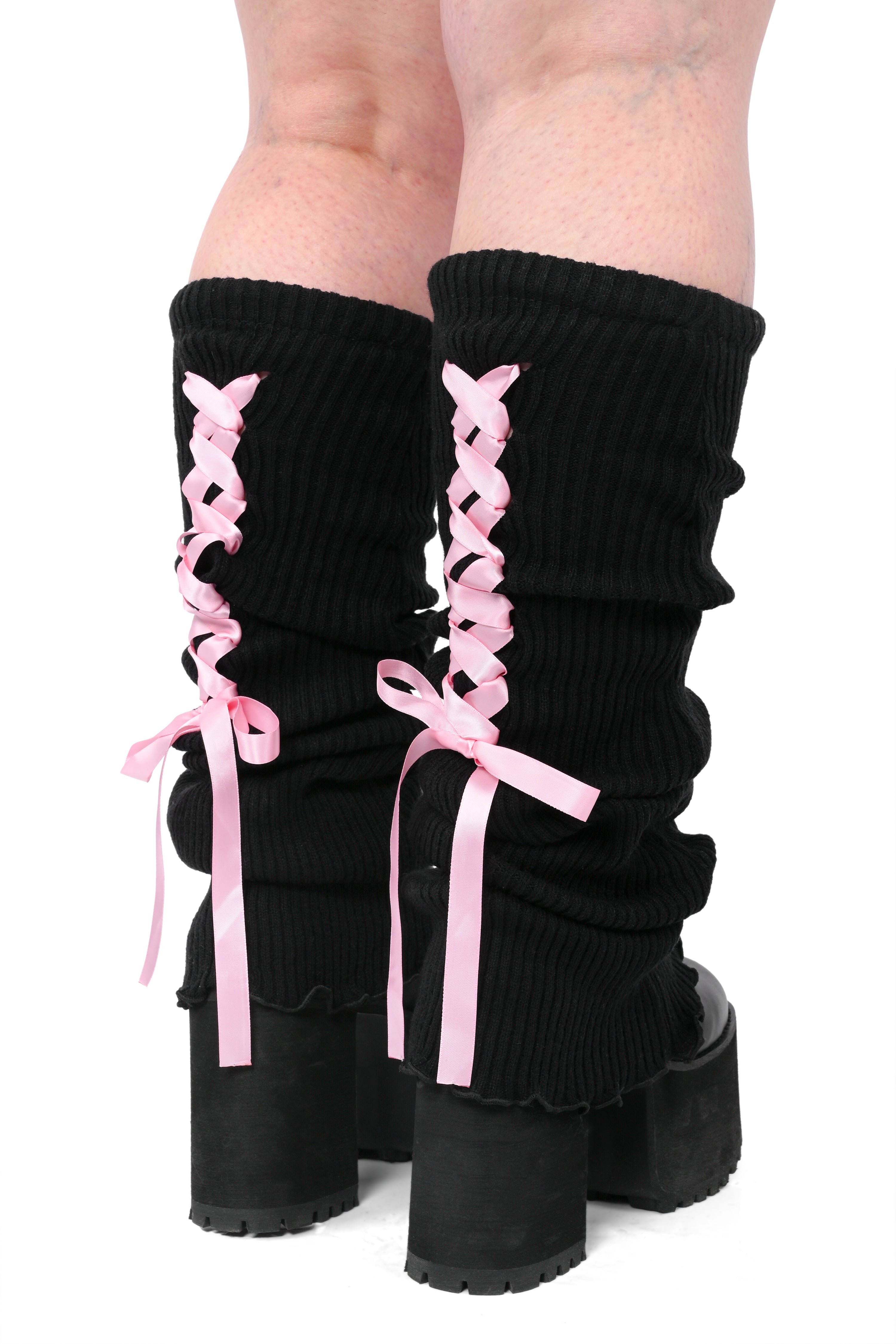 A pair of black legwarmers with pink laces