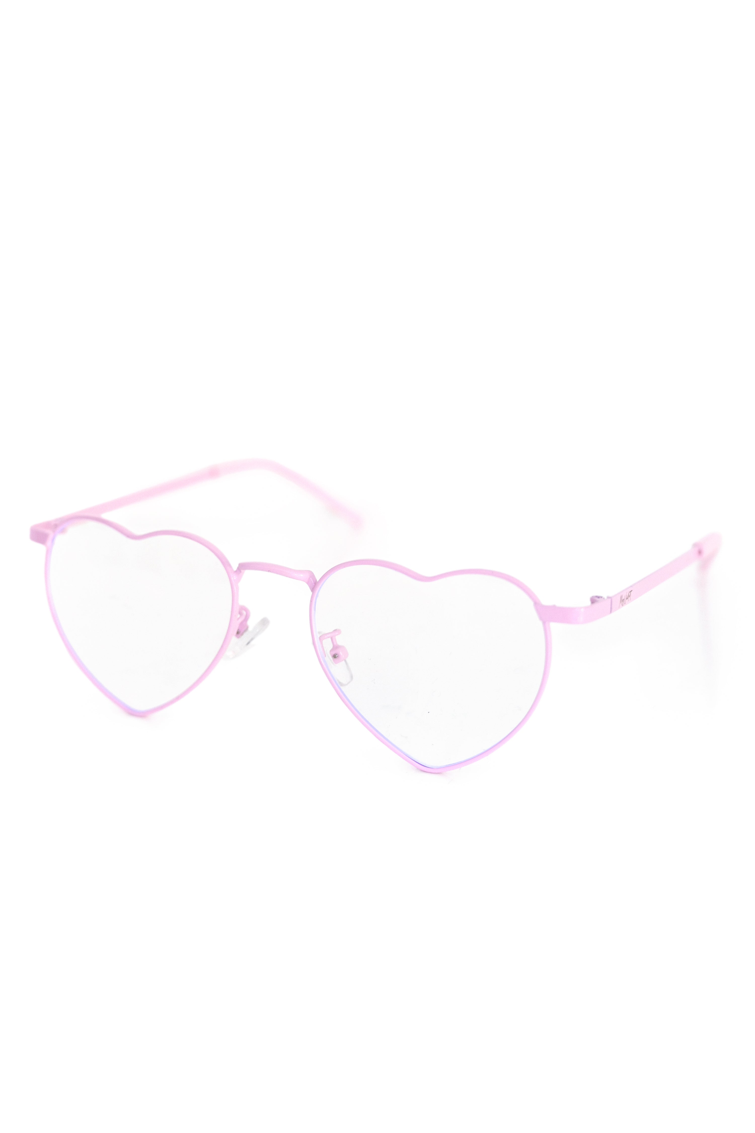 A close up shot of pink heart shaped glasses on a white background