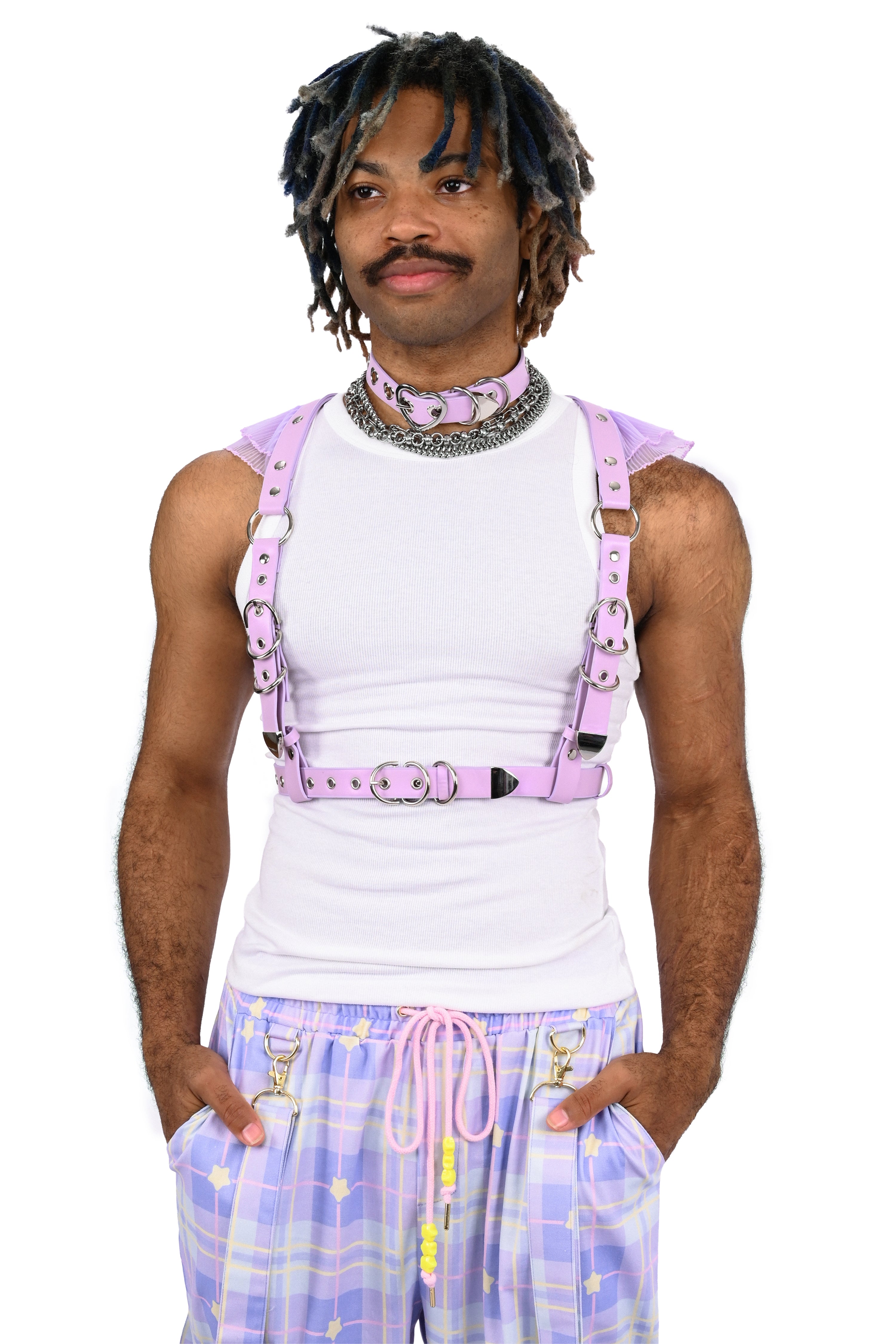 Person wearing a white tank top and purple suspenders on a white background