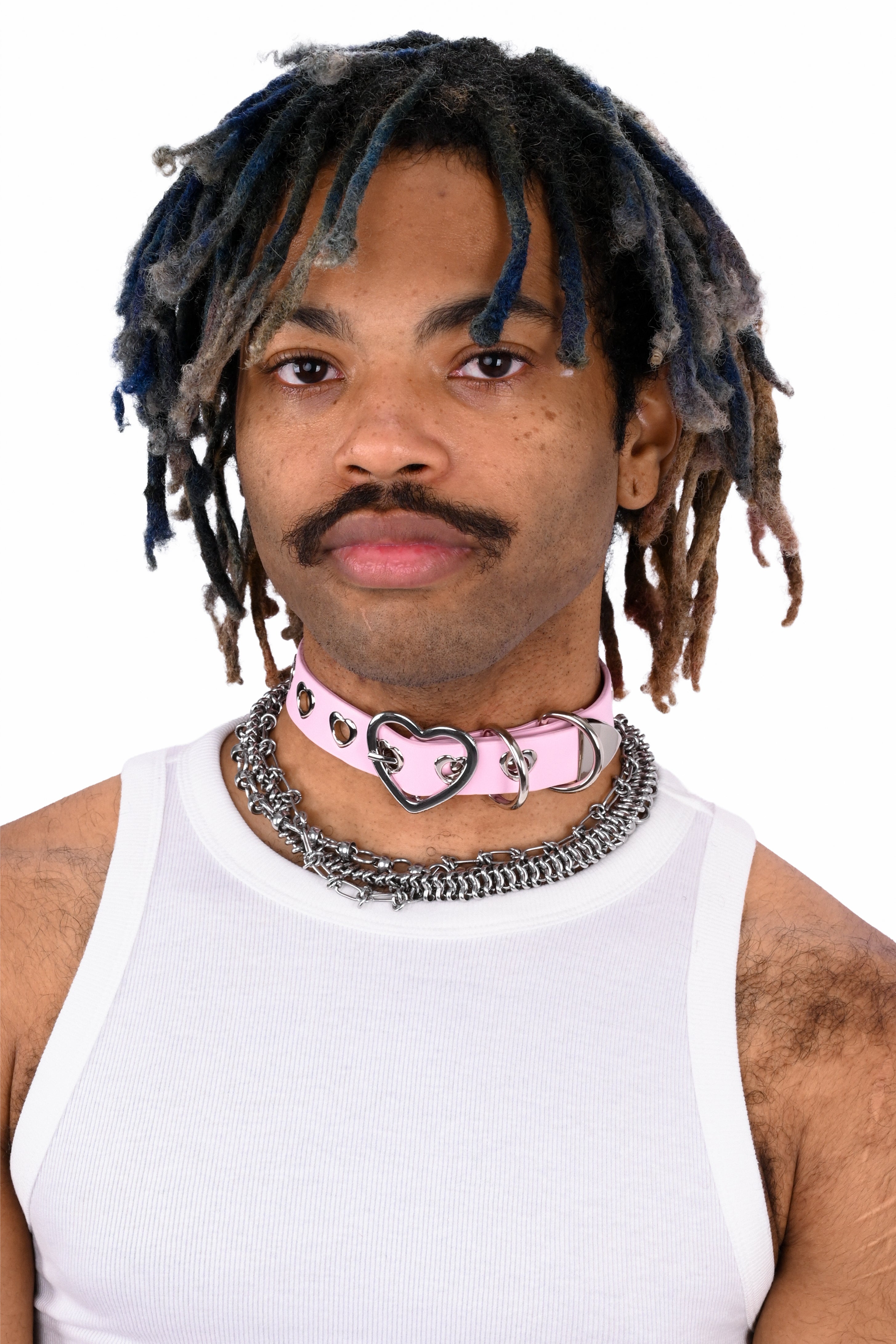 Person wearing a white tank top and pink choker with heart design on a white background
