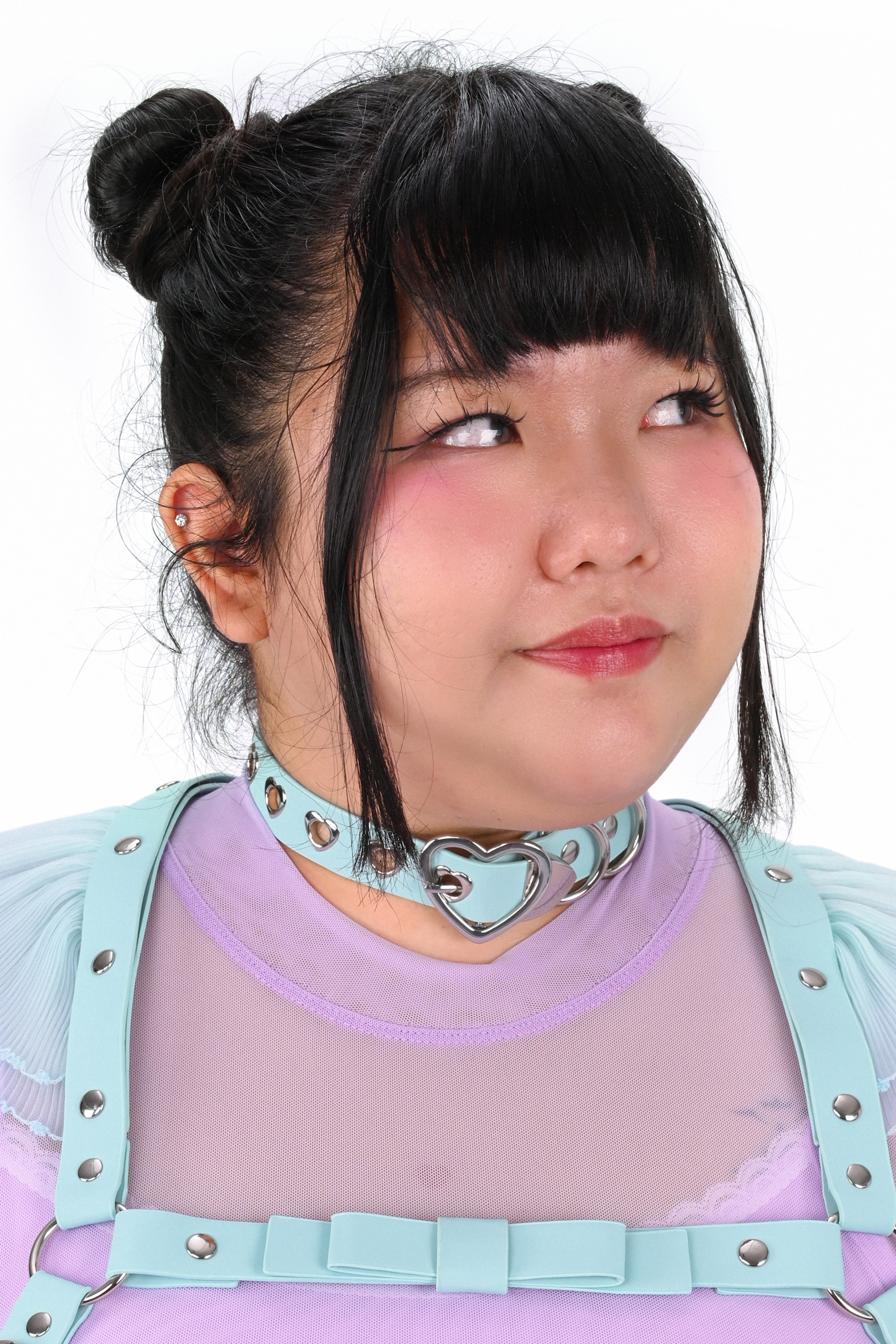 Person wearing a light blue choker with a heart design on a white background