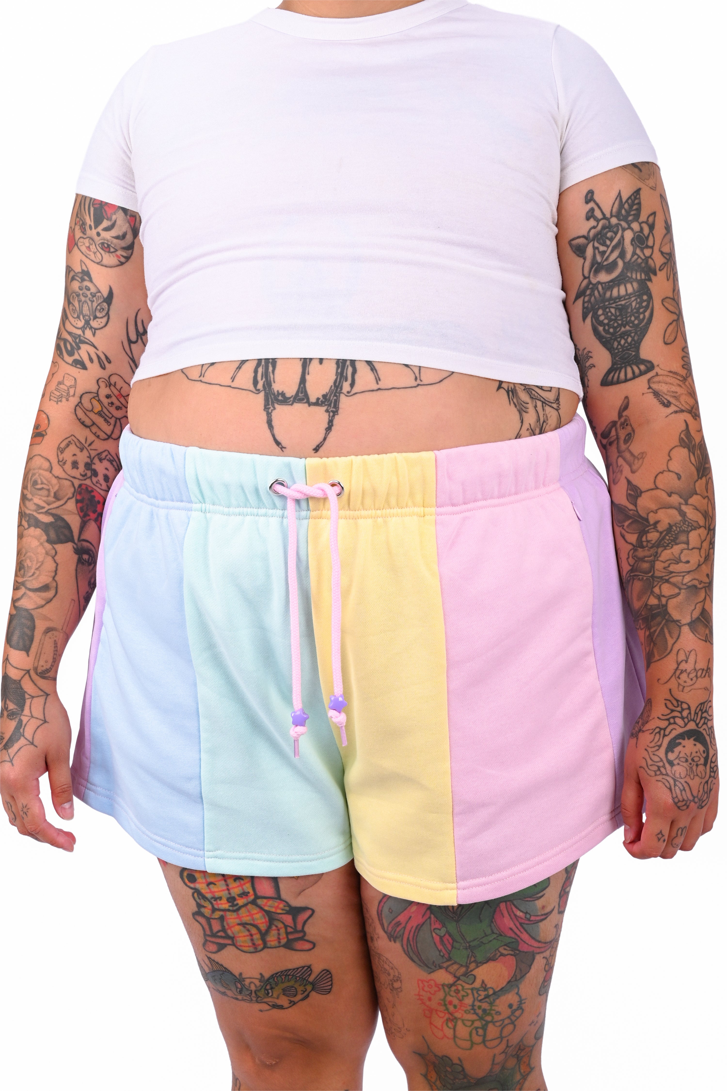 Person wearing a white t-shirt and colorful color blocked shorts