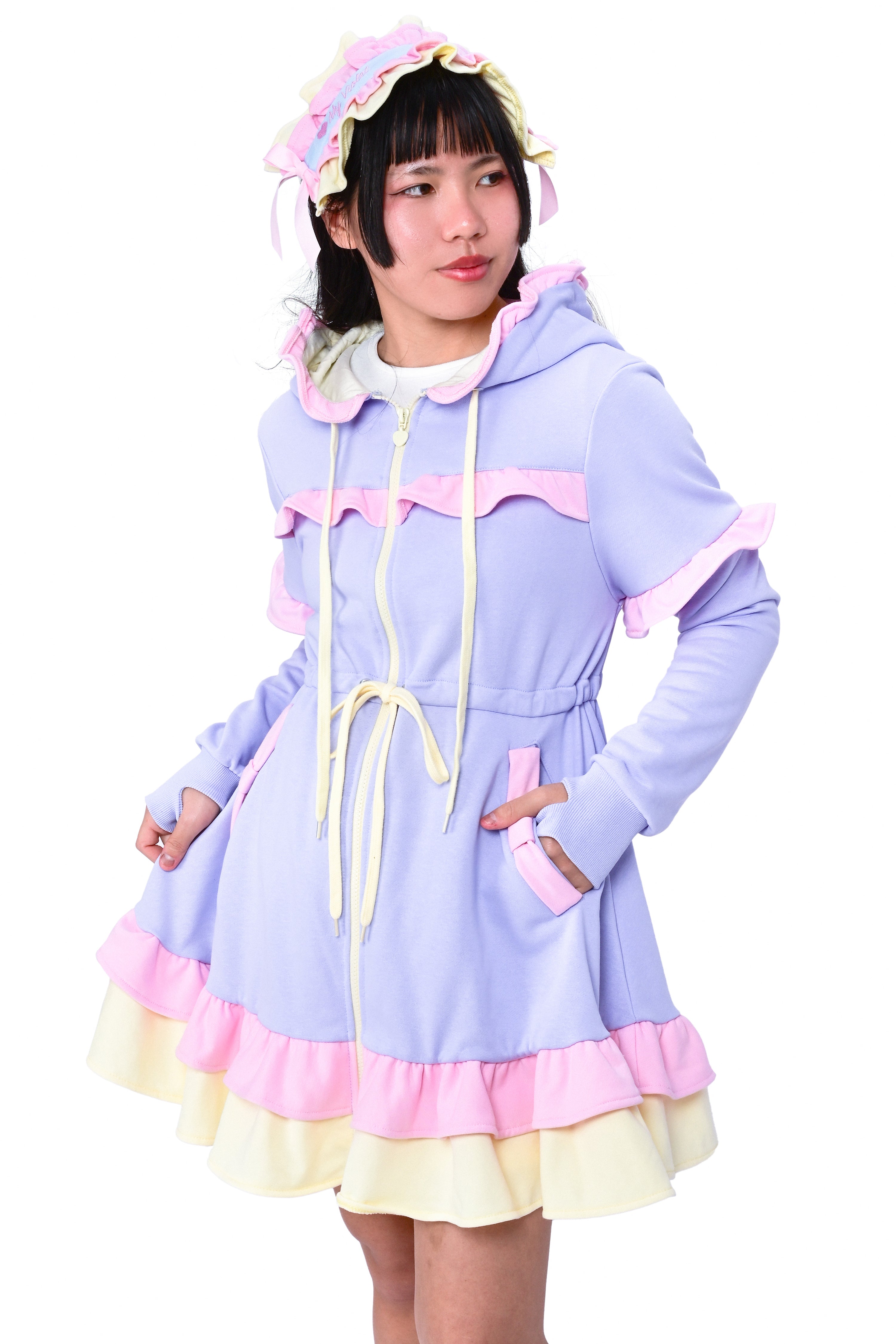 A person wearing a periwinkle hoodie dress set with long sleeves, hood, and ruffled skirt, paired with a matching headdress