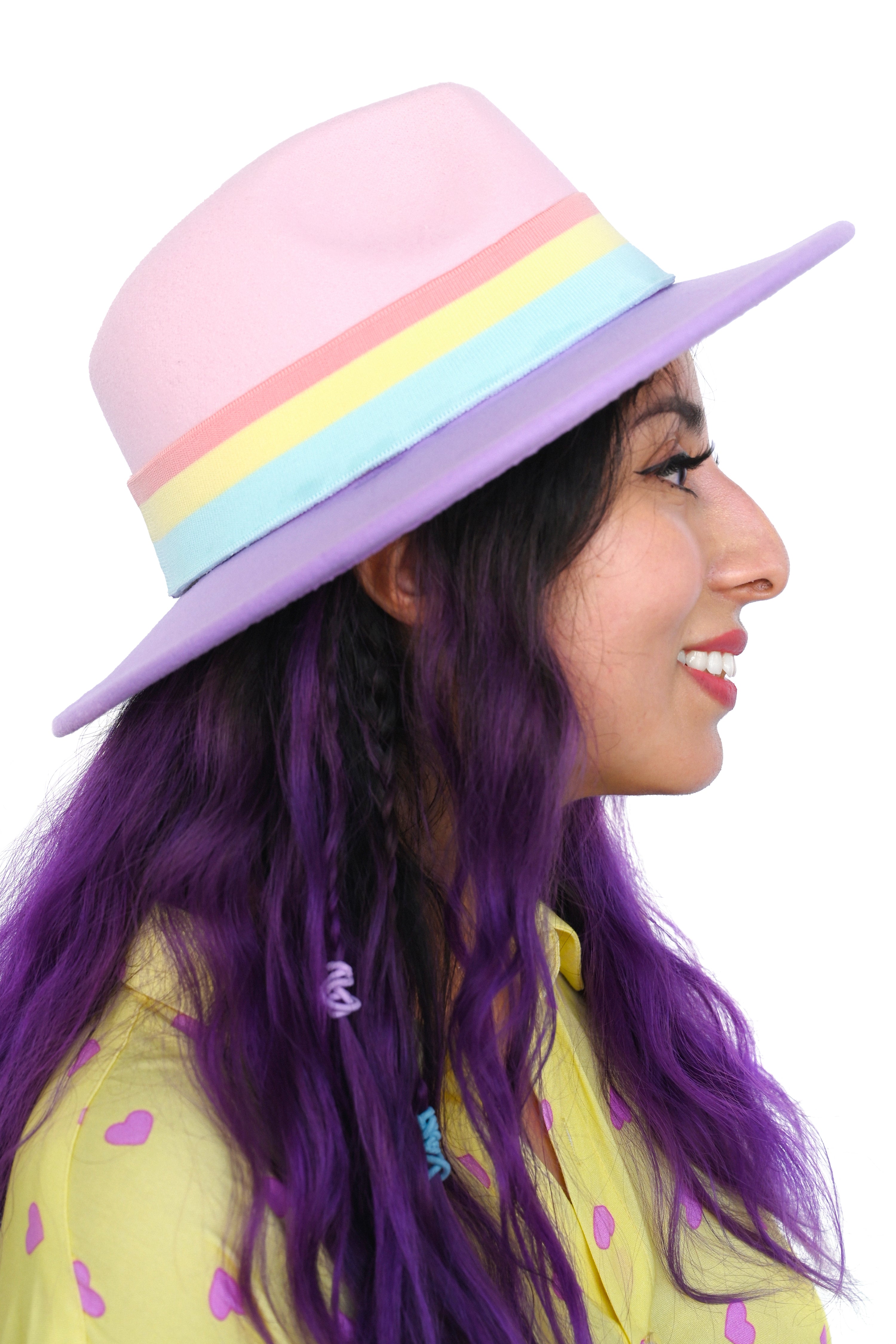 Hard brim hat with baby-pink crown and lavender brim,  and a striped rainbow hat band.