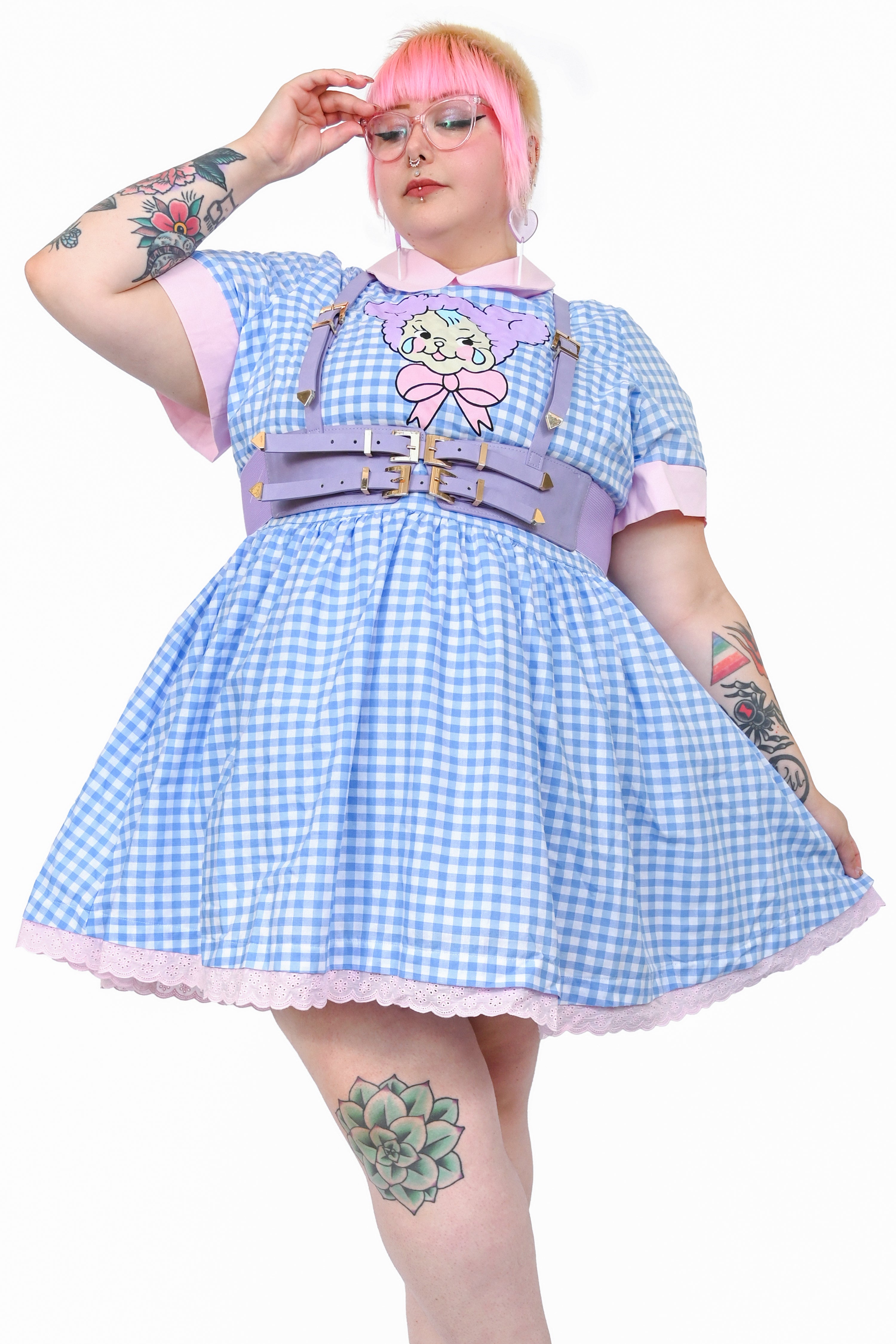 Knee length gingham dress with pink collar and trim, featuring a cute crying teddy bear graphic on the front