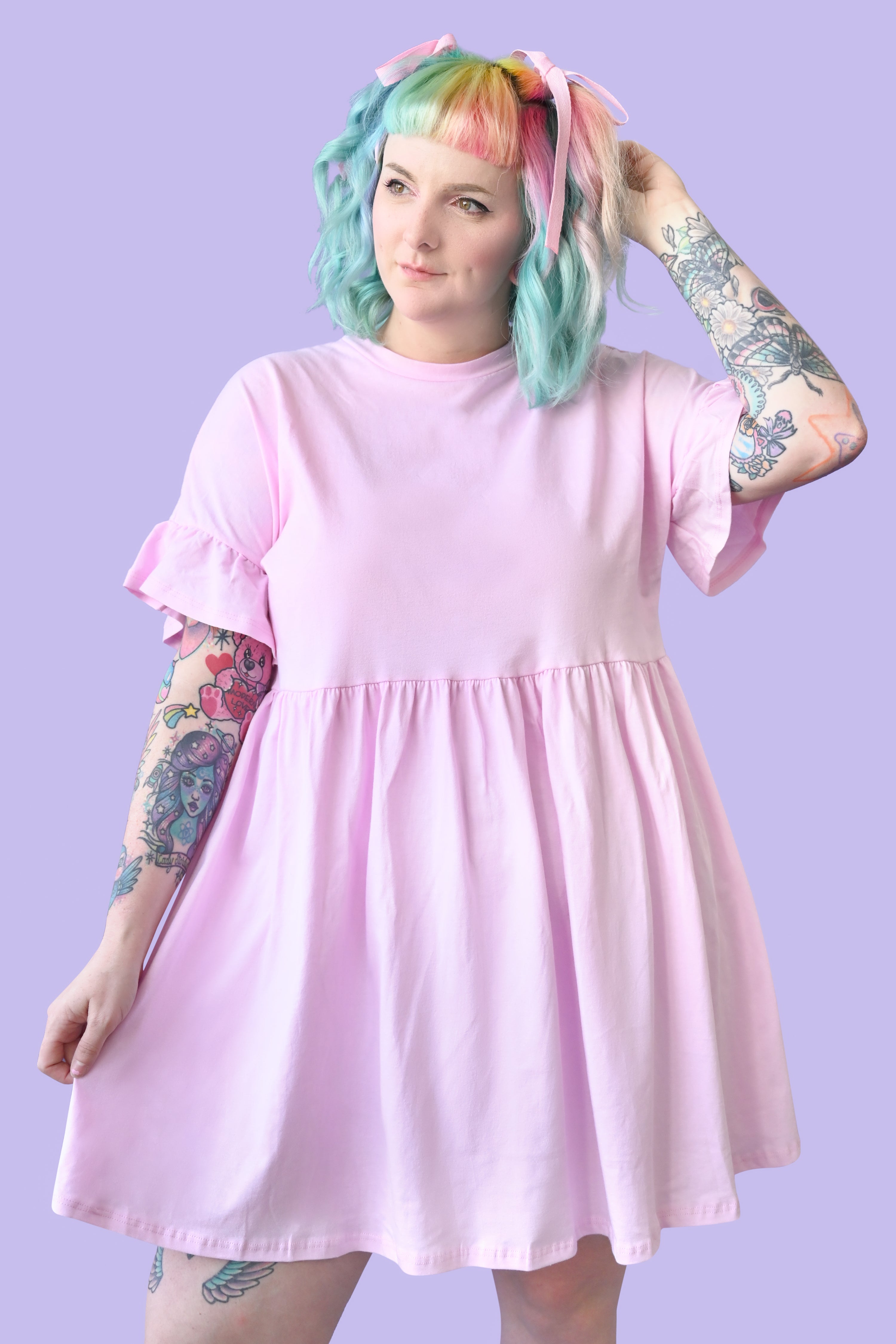 Light pink colored loose fitting cotton dress with ruffled sleeves