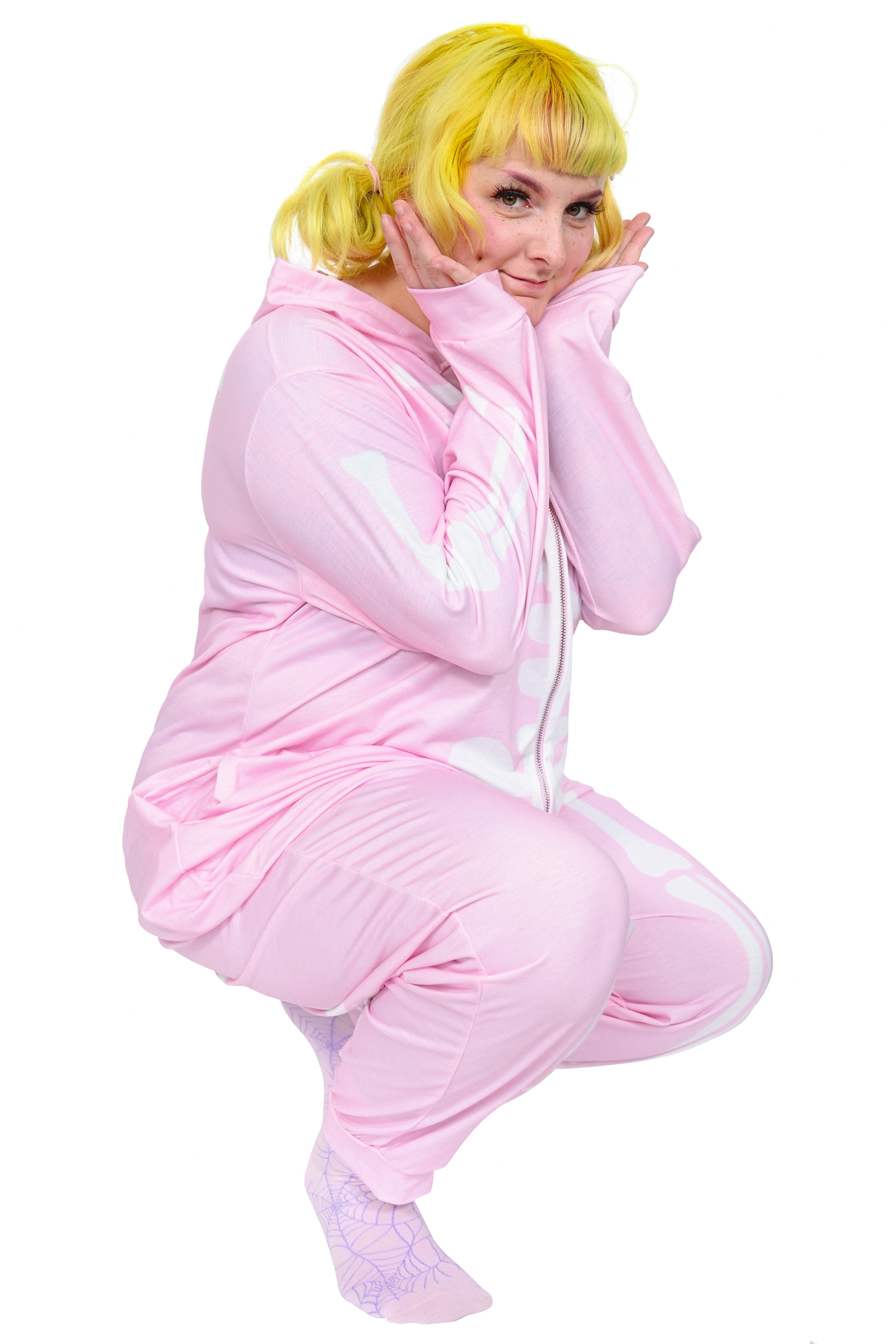 Pastel pink oversized onesie with full front and back white skeleton print.