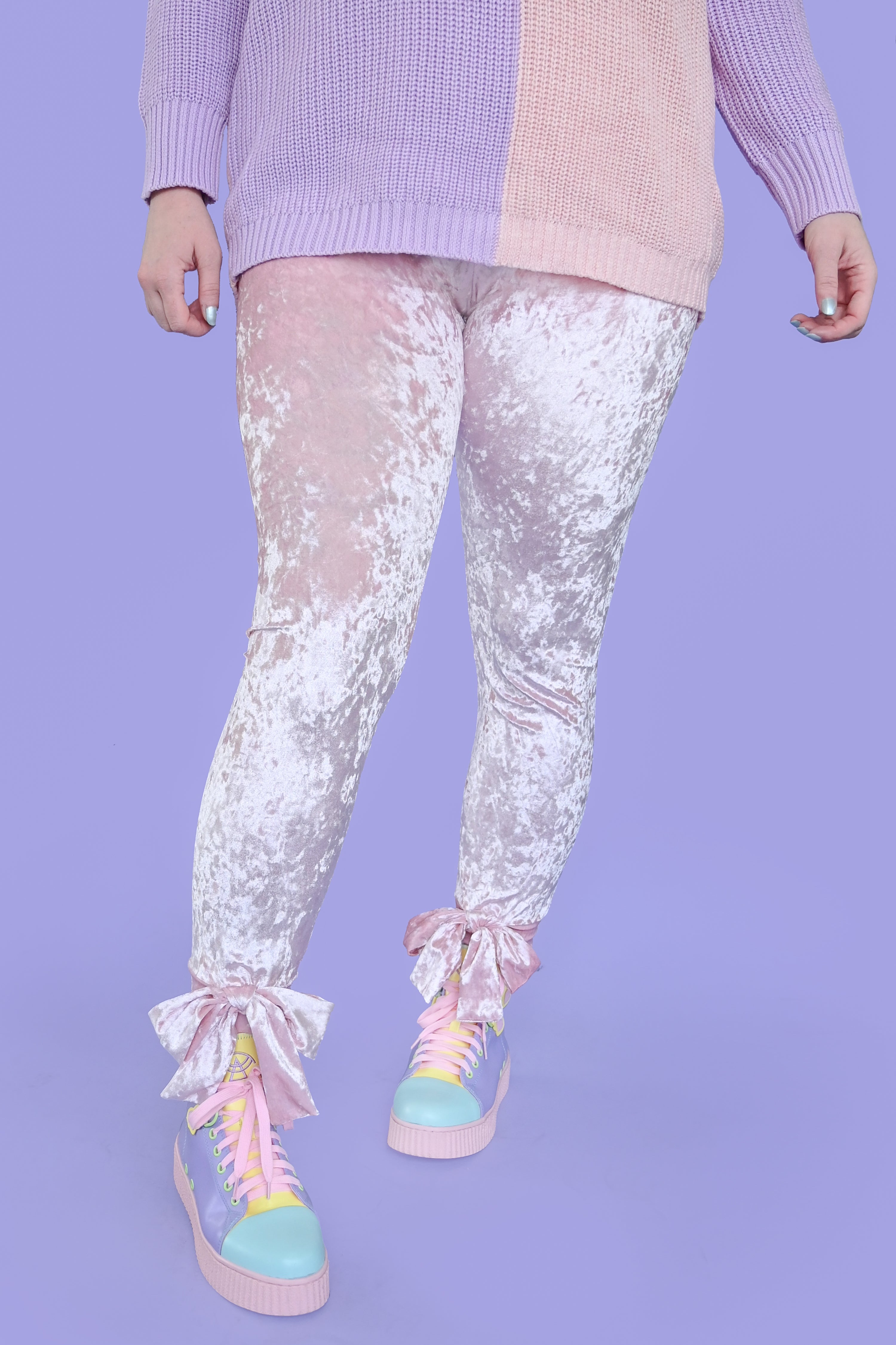 Light pink crushed velvet leggings with bows at the ankles