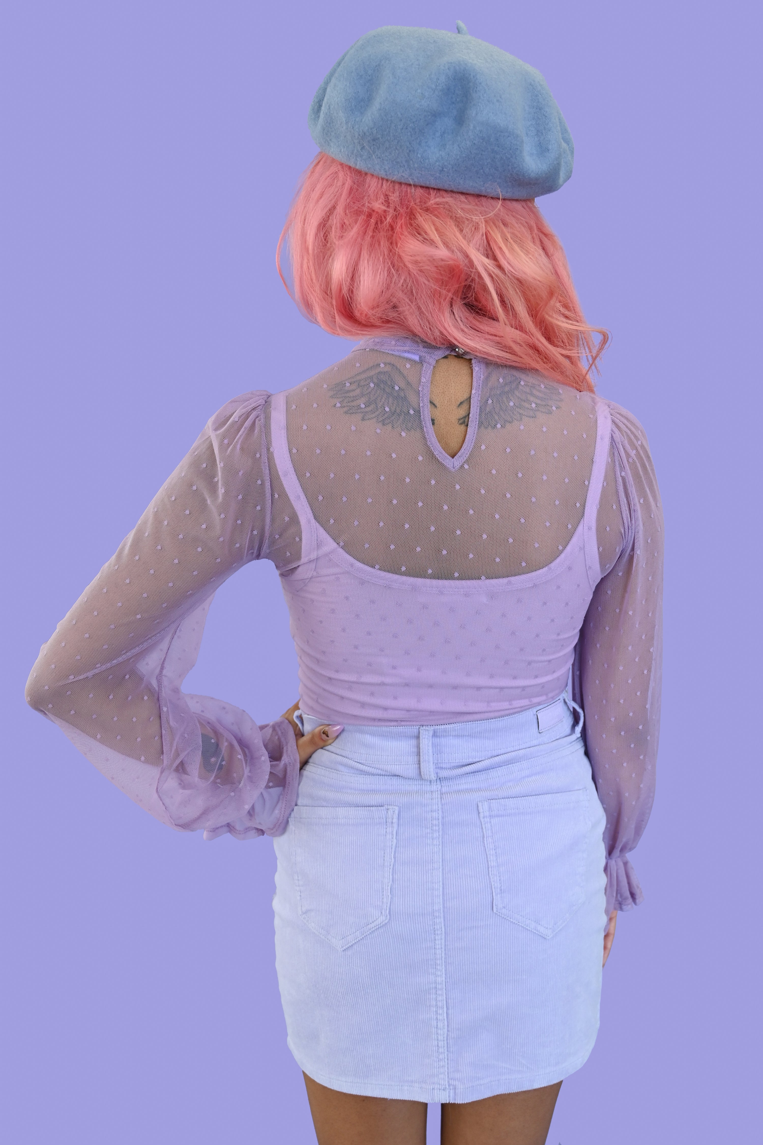 sheer lavender polka dot blouse with ruffled sleeves and peephole button closure on back