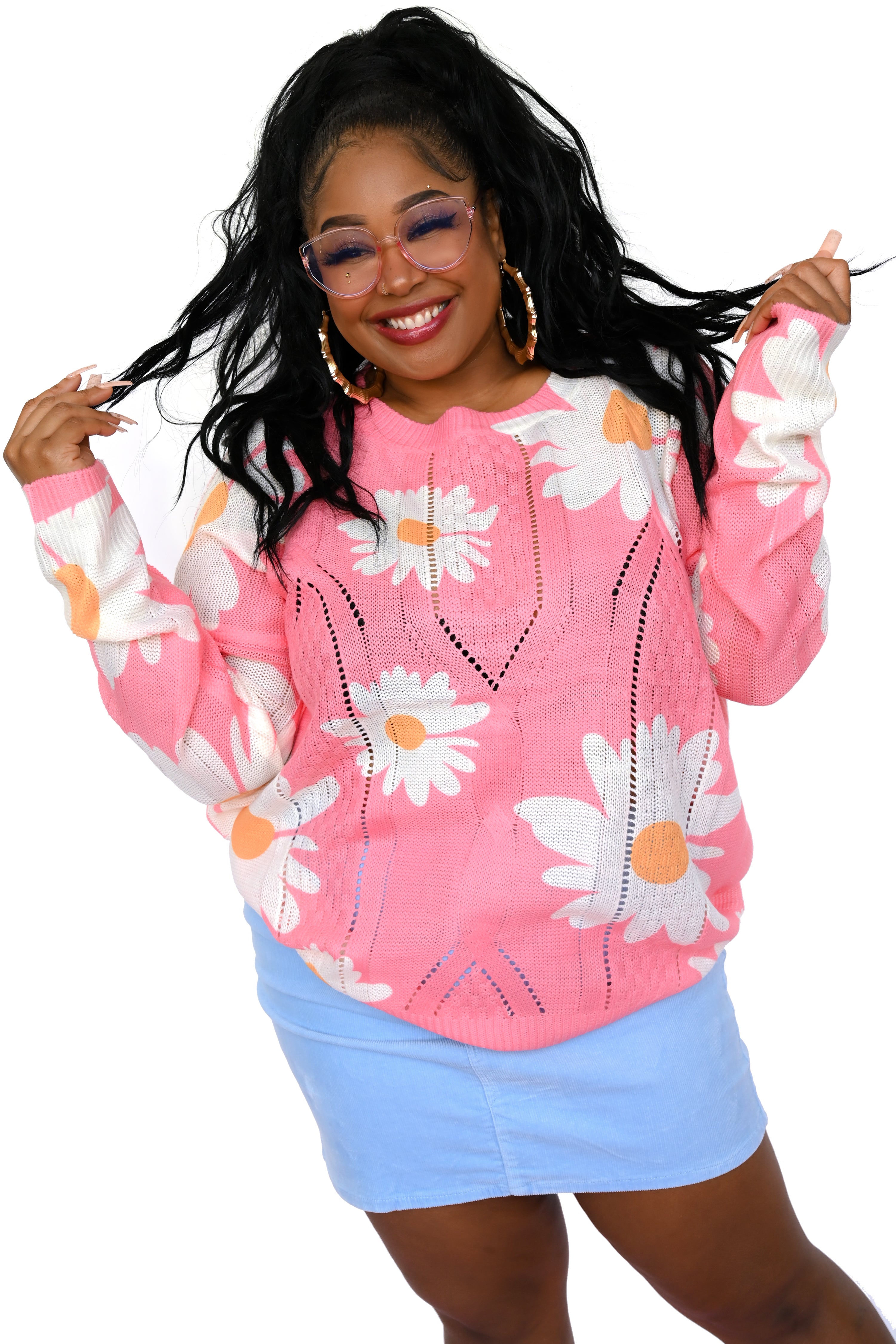 Model wearing pink oversized sweater with daisy pattern