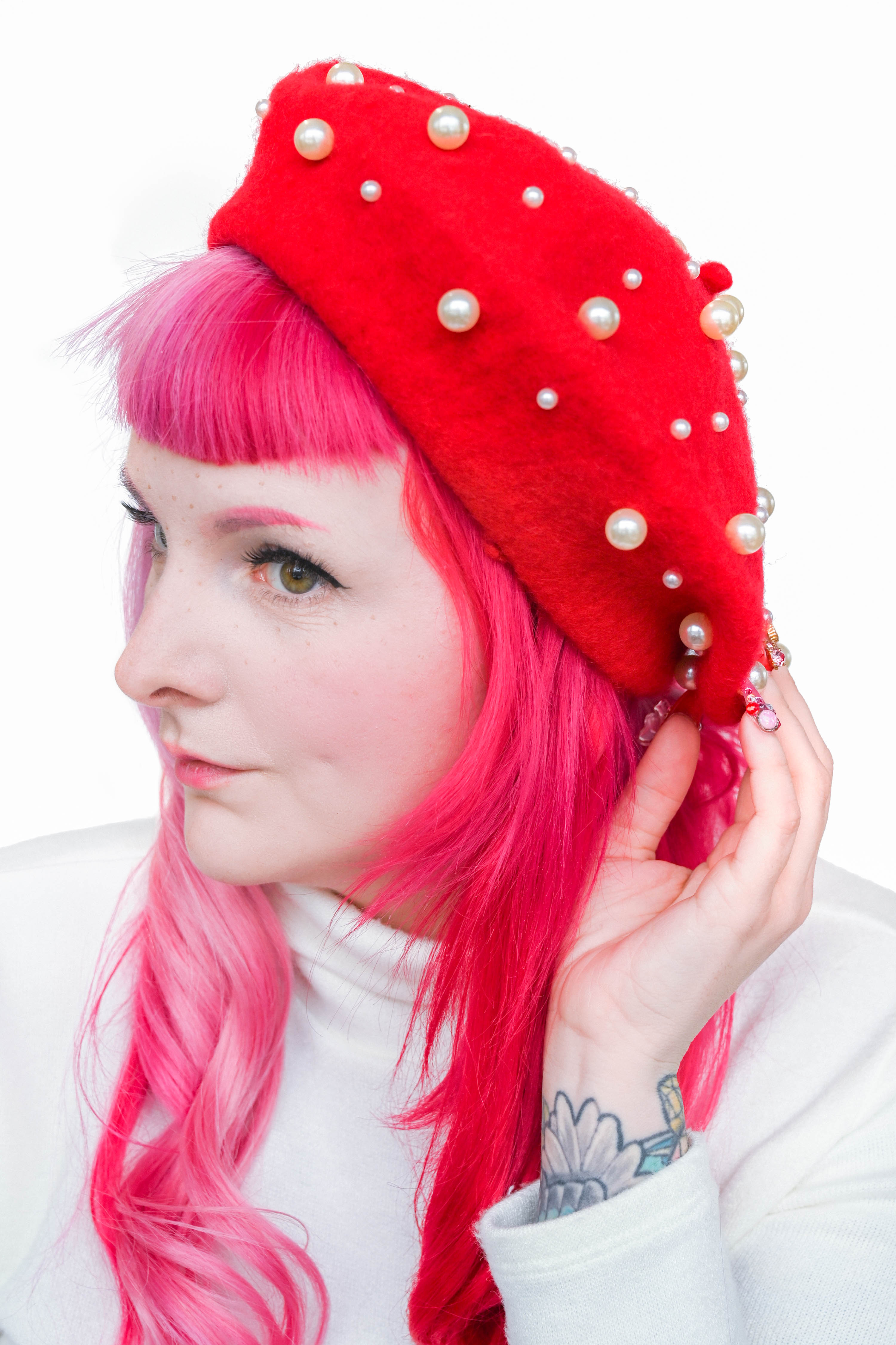 red beret with two different sized pearls all over