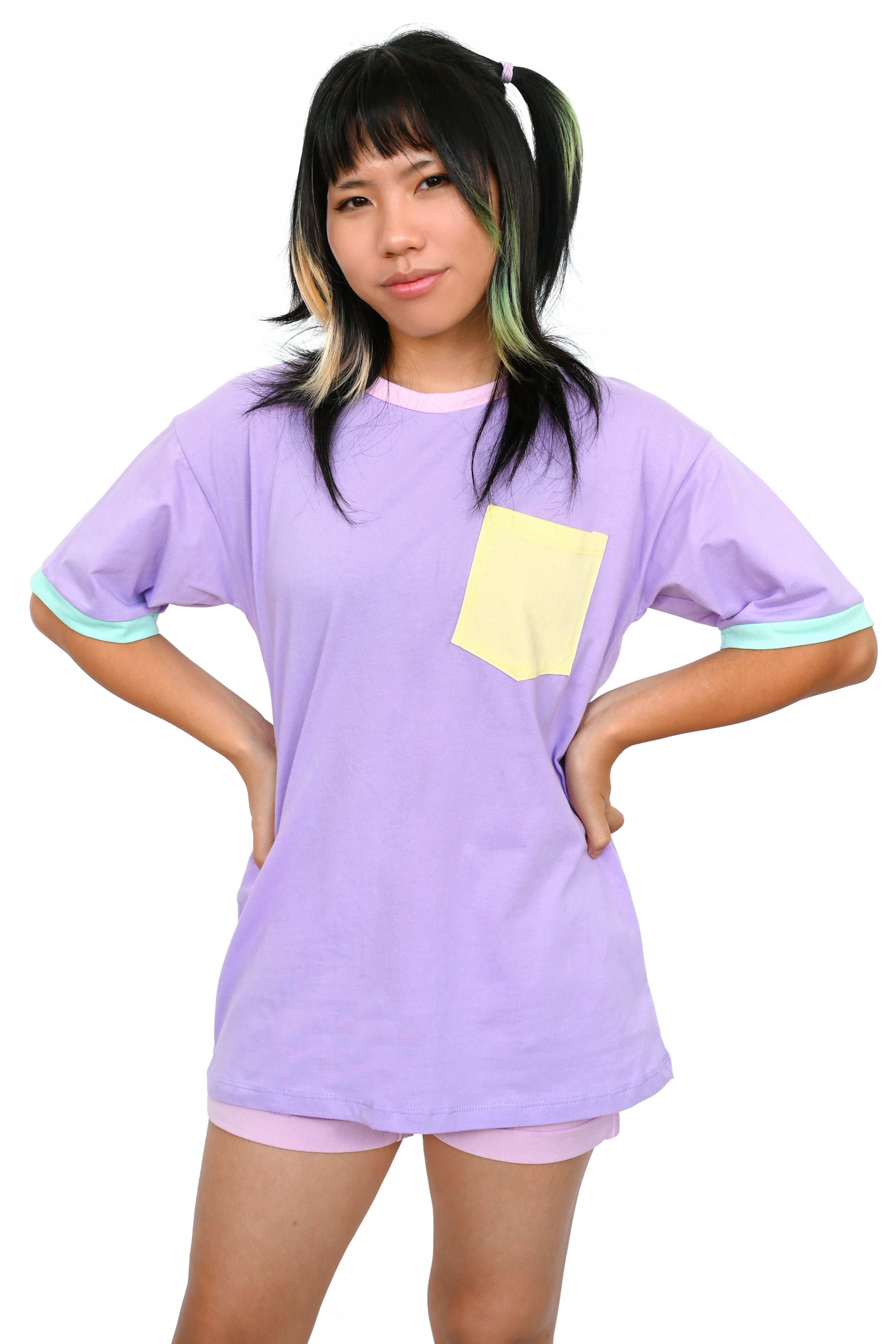 Model wearing oversized lavender tee with mint and pink trim and yellow lapel pocket