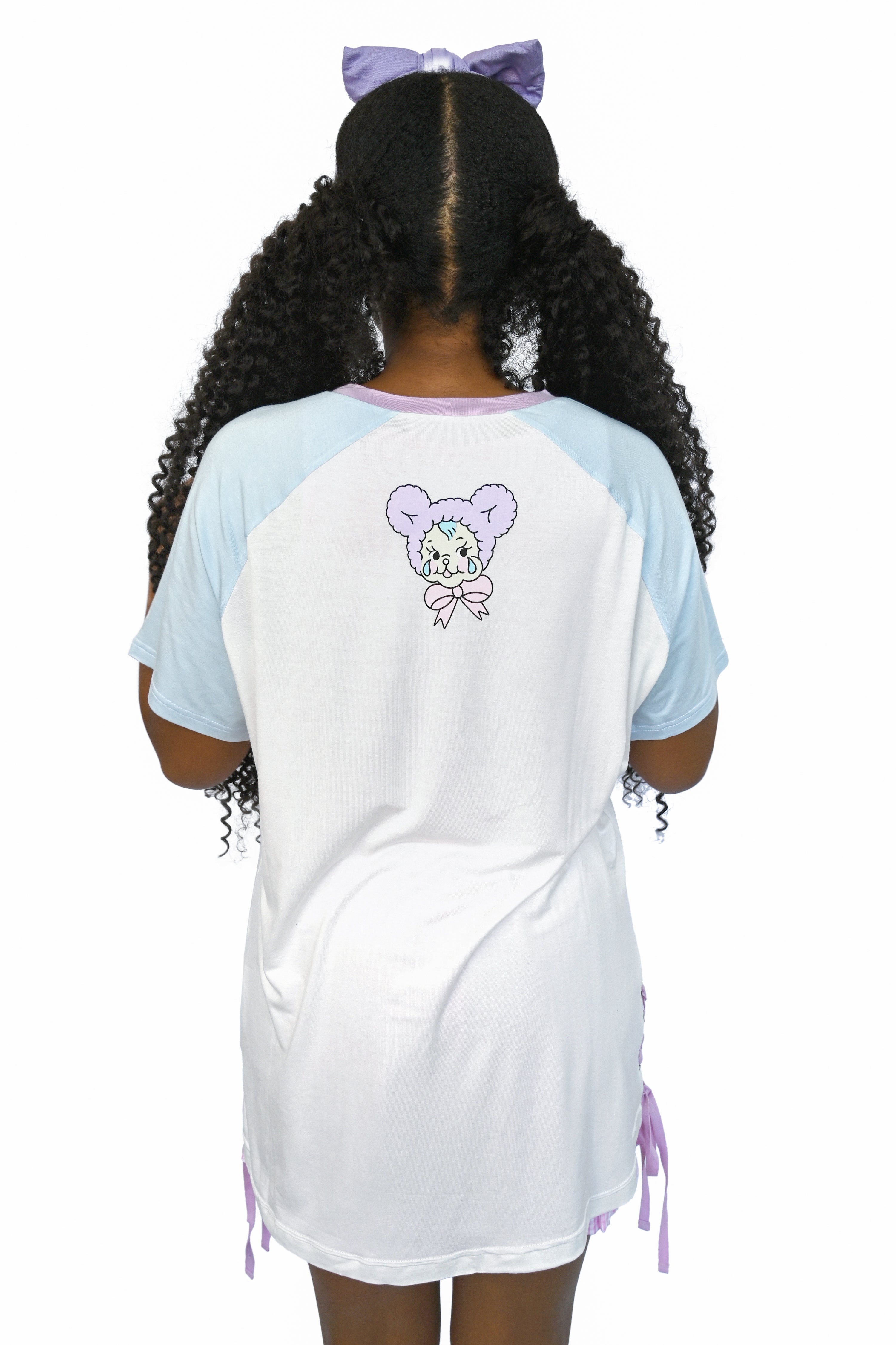 White raglan tee with sky blue sleeves, featuring a graphic with  pink bunny holding balloons