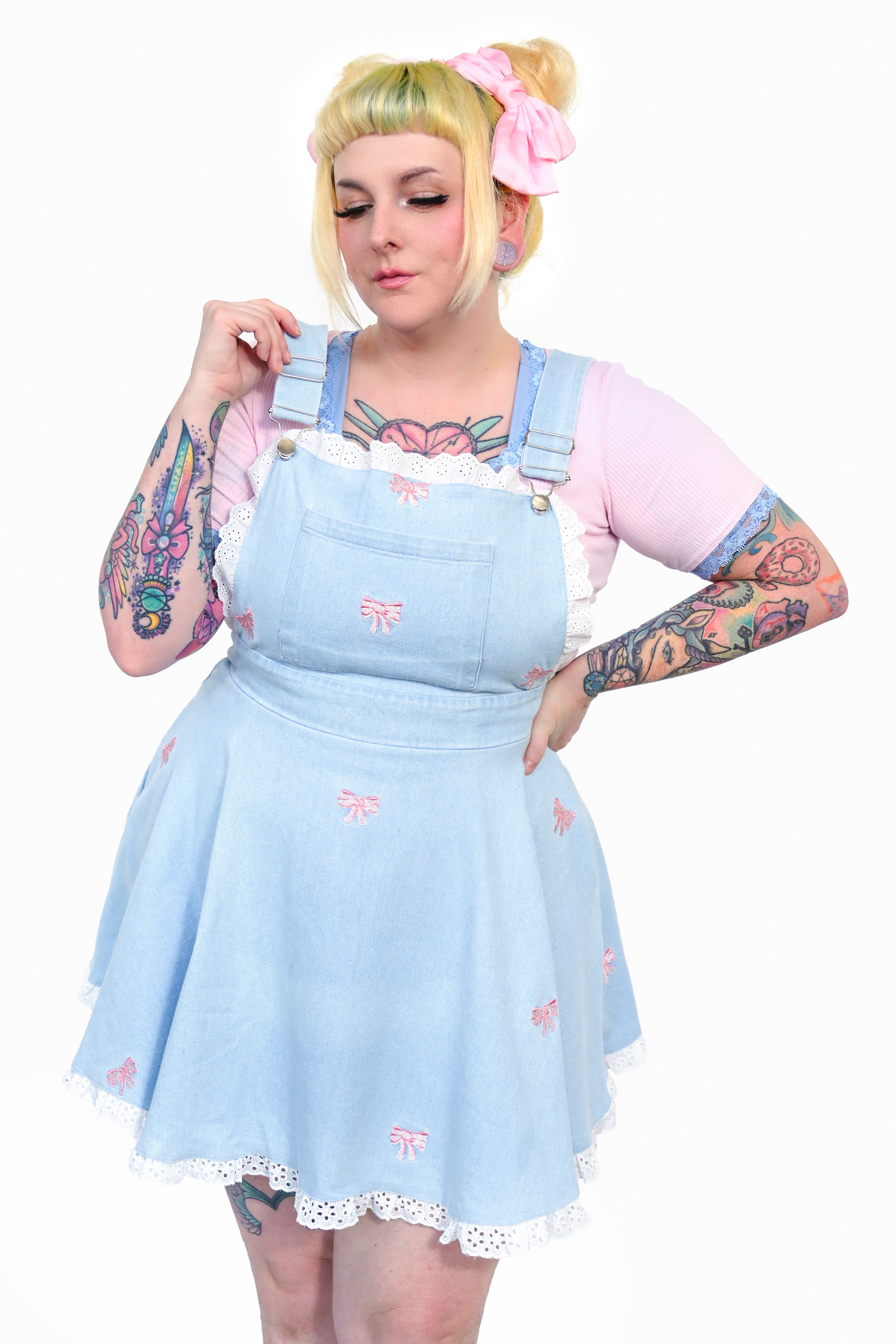 Light wash denim pinafore with eyelet lace ruffle trum and embroidered pink bows all over