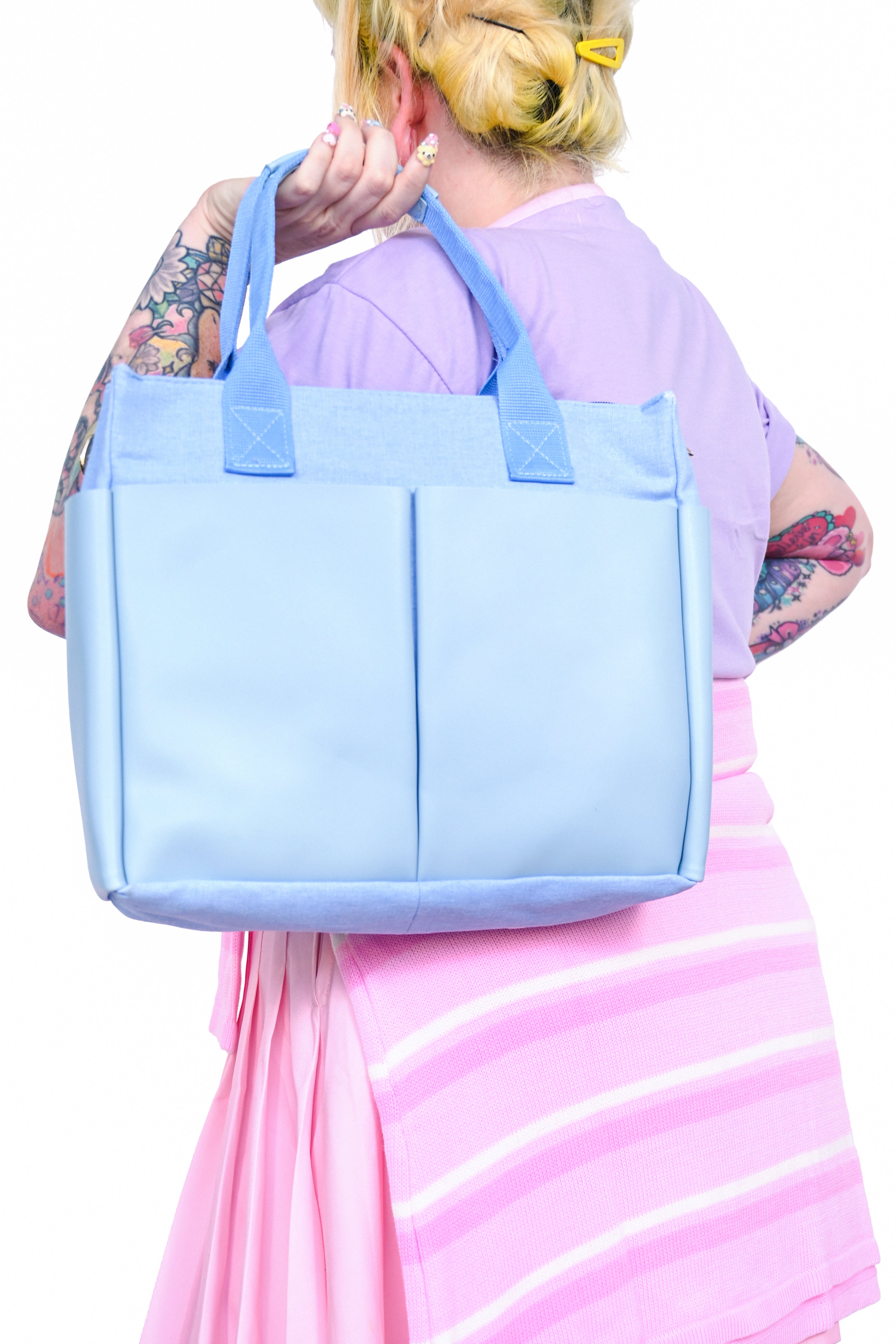 Rectangular blue bag with large outer pockets and two sturdy canvas straps