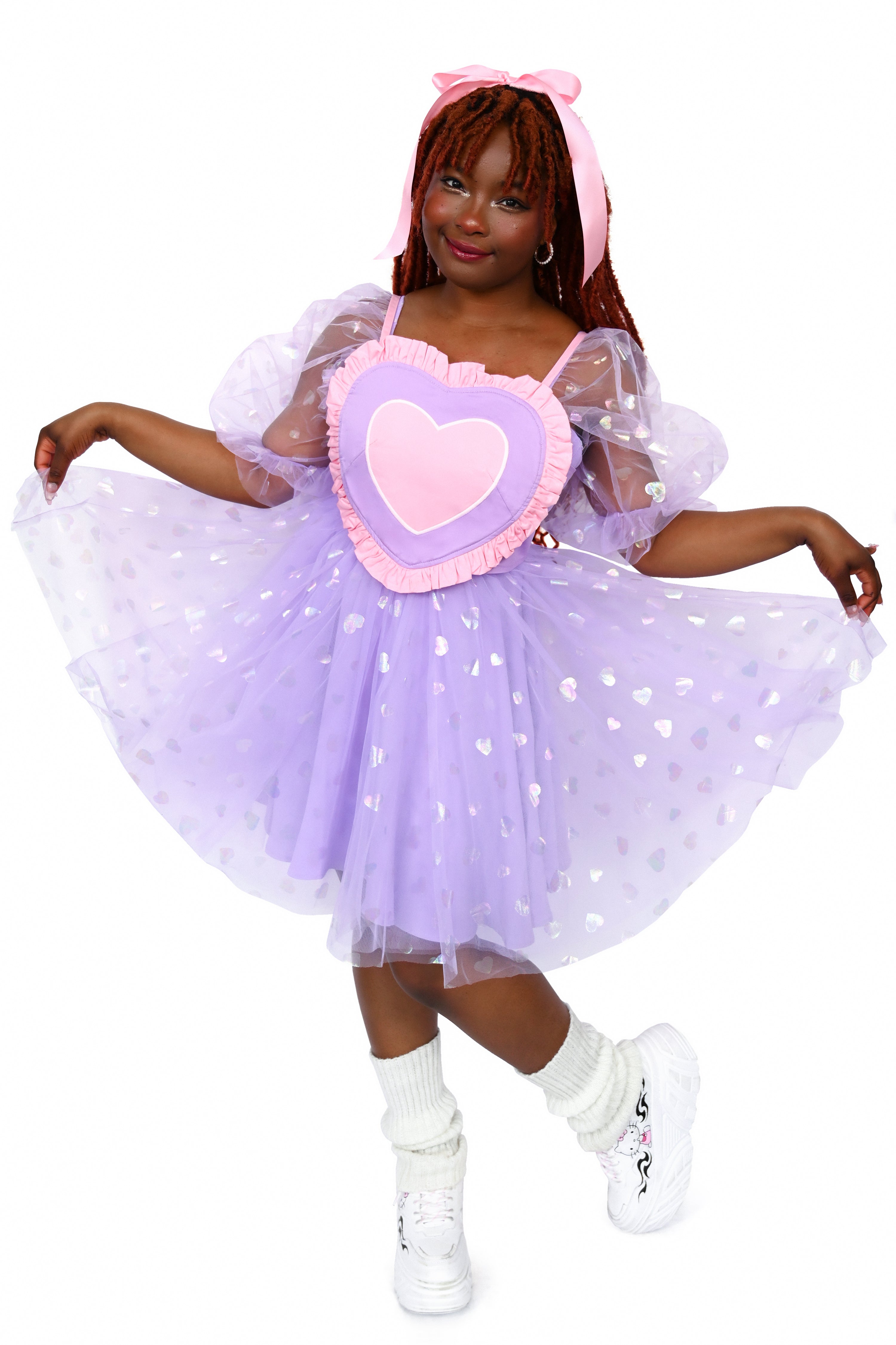 This pink, lavender, white, and light pink heart shaped corset top has adjustable straps and a lace-up back. The Base color of the corset top is lavender and a pink ruffle surrounds the other colours of the heart.