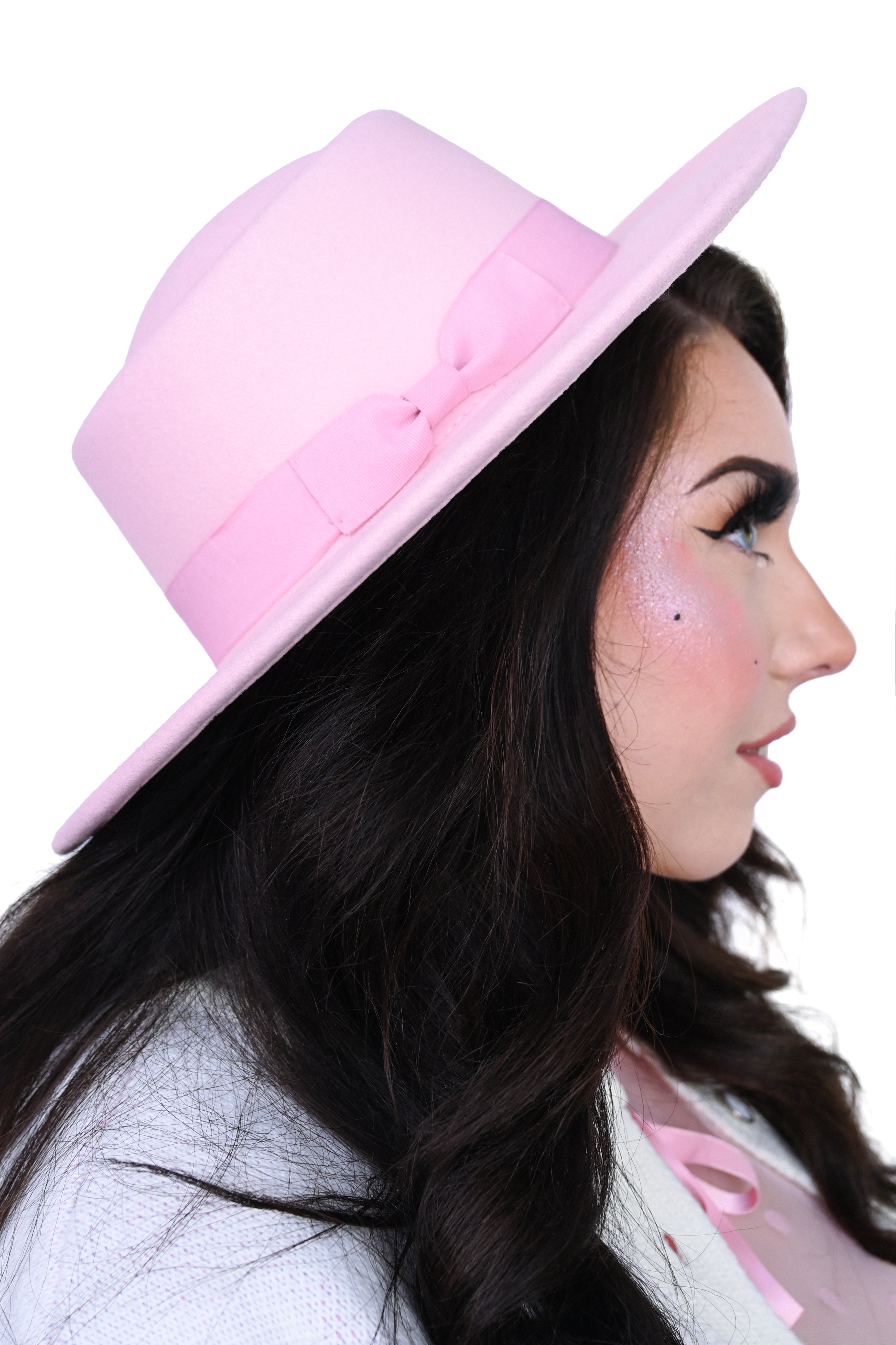 Pastel pink hard brim hat with bow detail on the hat band