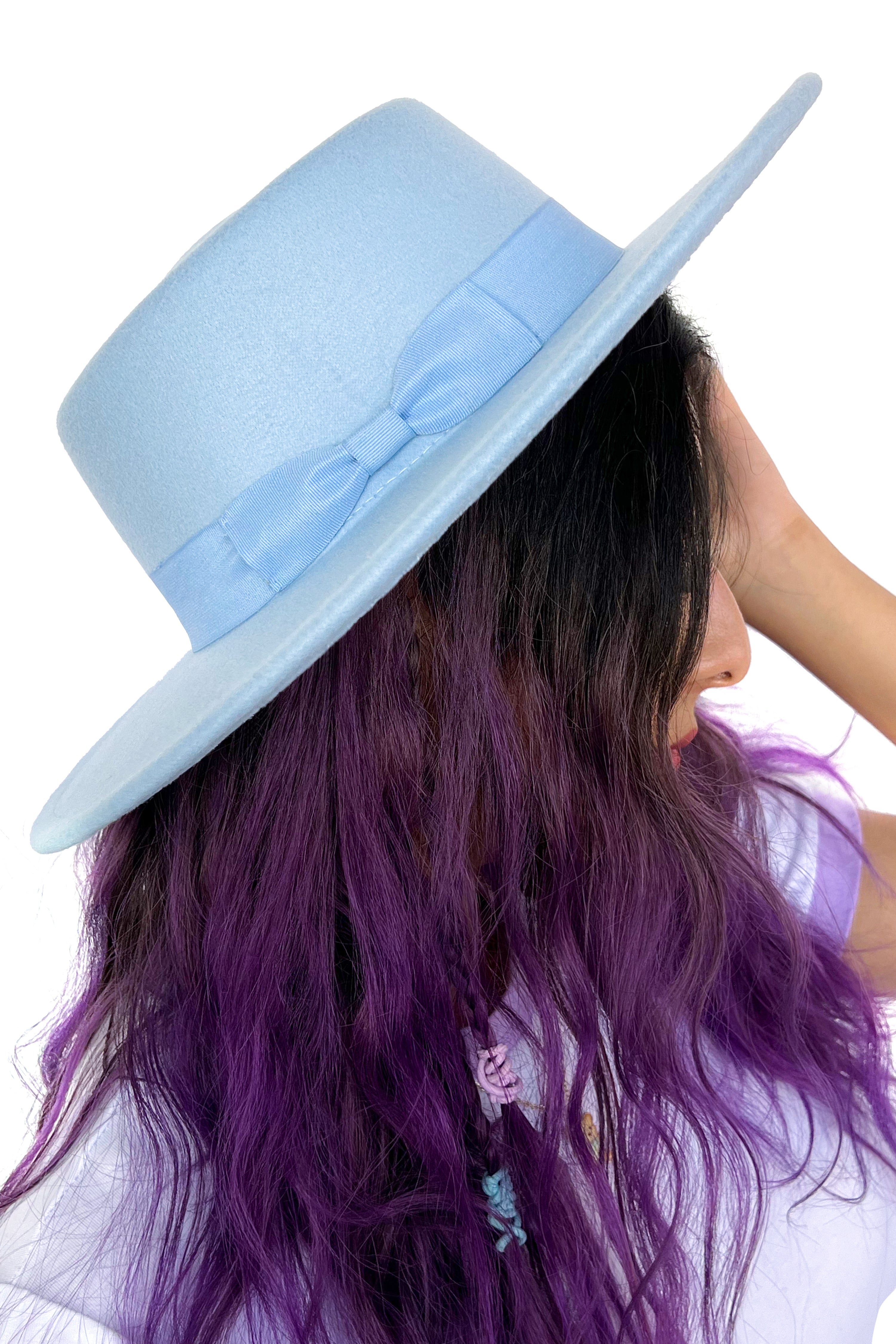 Model wearing a blue felted hard brim hat
